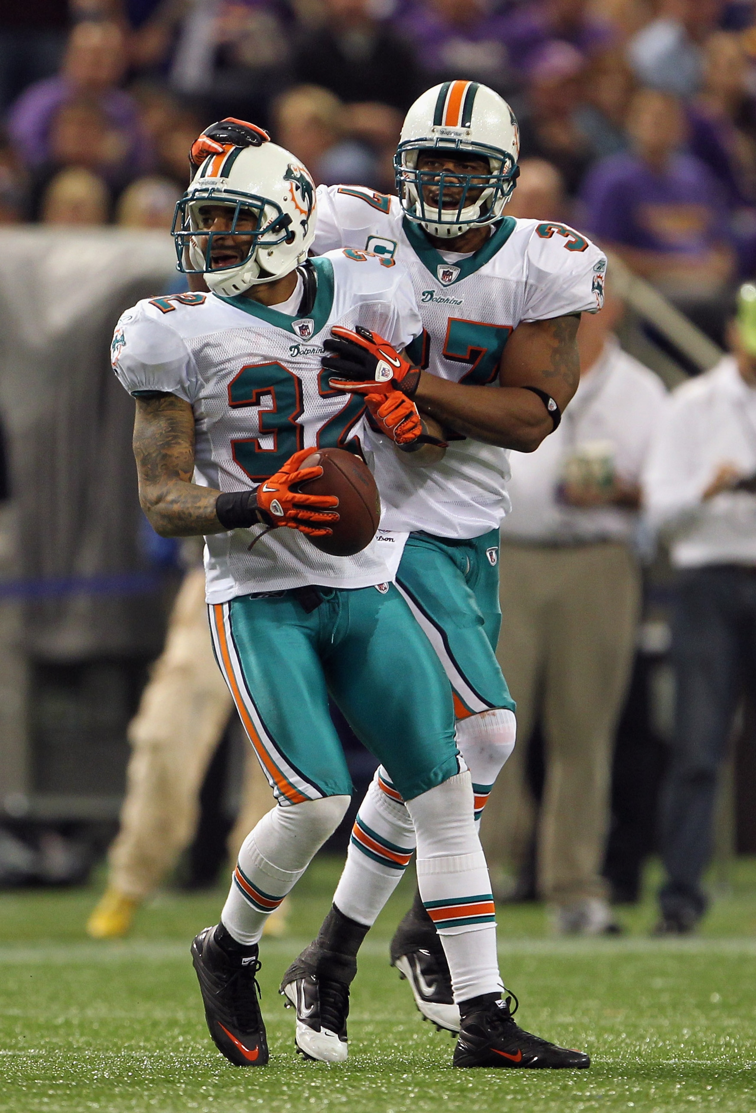MINNEAPOLIS - SEPTEMBER 19:  Jason Allen #32 of the Miami Dolphins is congratulated by Yeremiah Bell #37 after an interception during the game on September 19, 2010 at Hubert H. Humphrey Metrodome in Minneapolis, Minnesota.  (Photo by Jamie Squire/Getty I