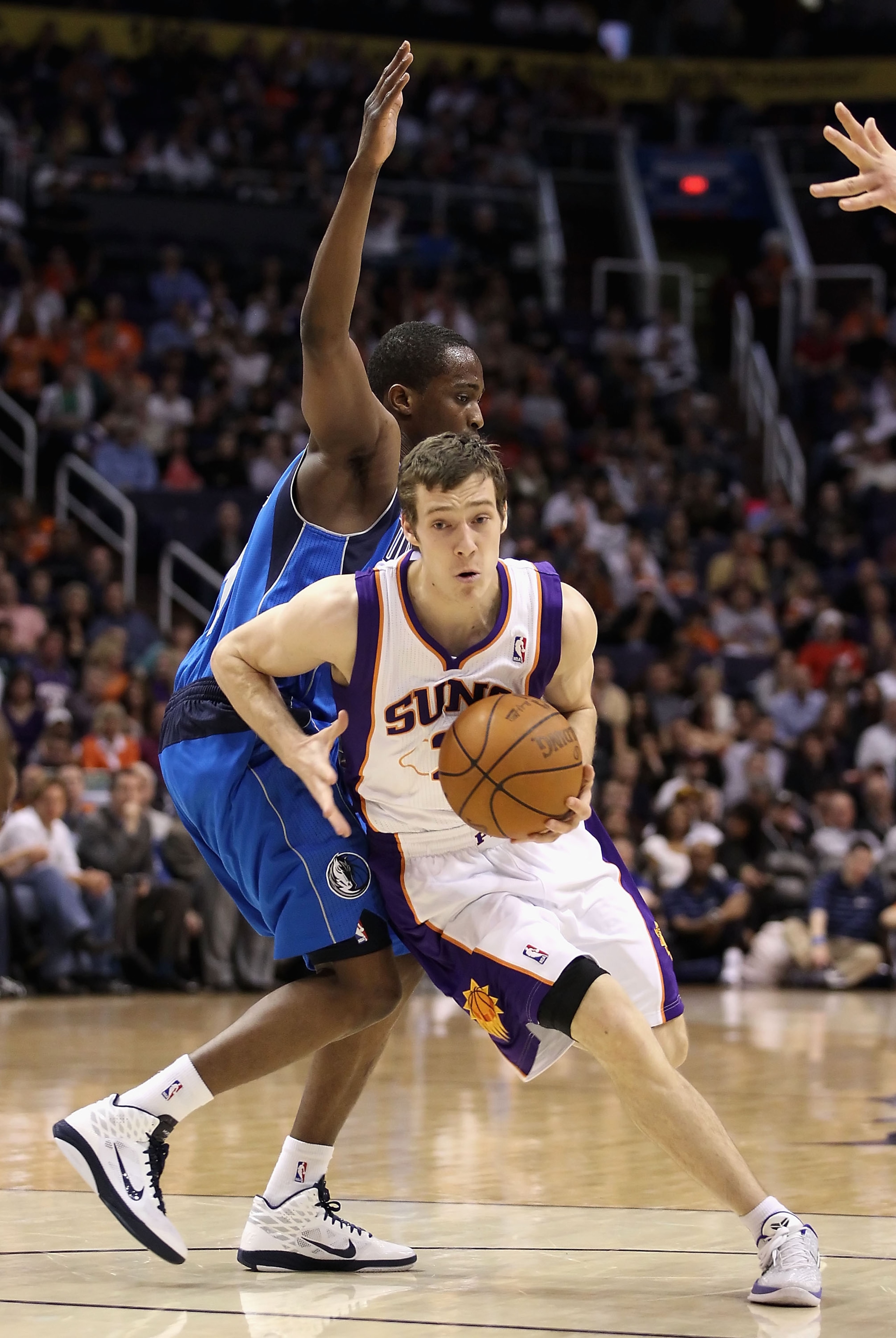 PHOENIX, AZ - FEBRUARY 17:  Goran Dragic #2 of the Phoenix Suns drives the ball past Rodrigue Beaubois #3 of the Dallas Mavericks during the NBA game at US Airways Center on February 17, 2011 in Phoenix, Arizona.  NOTE TO USER: User expressly acknowledges