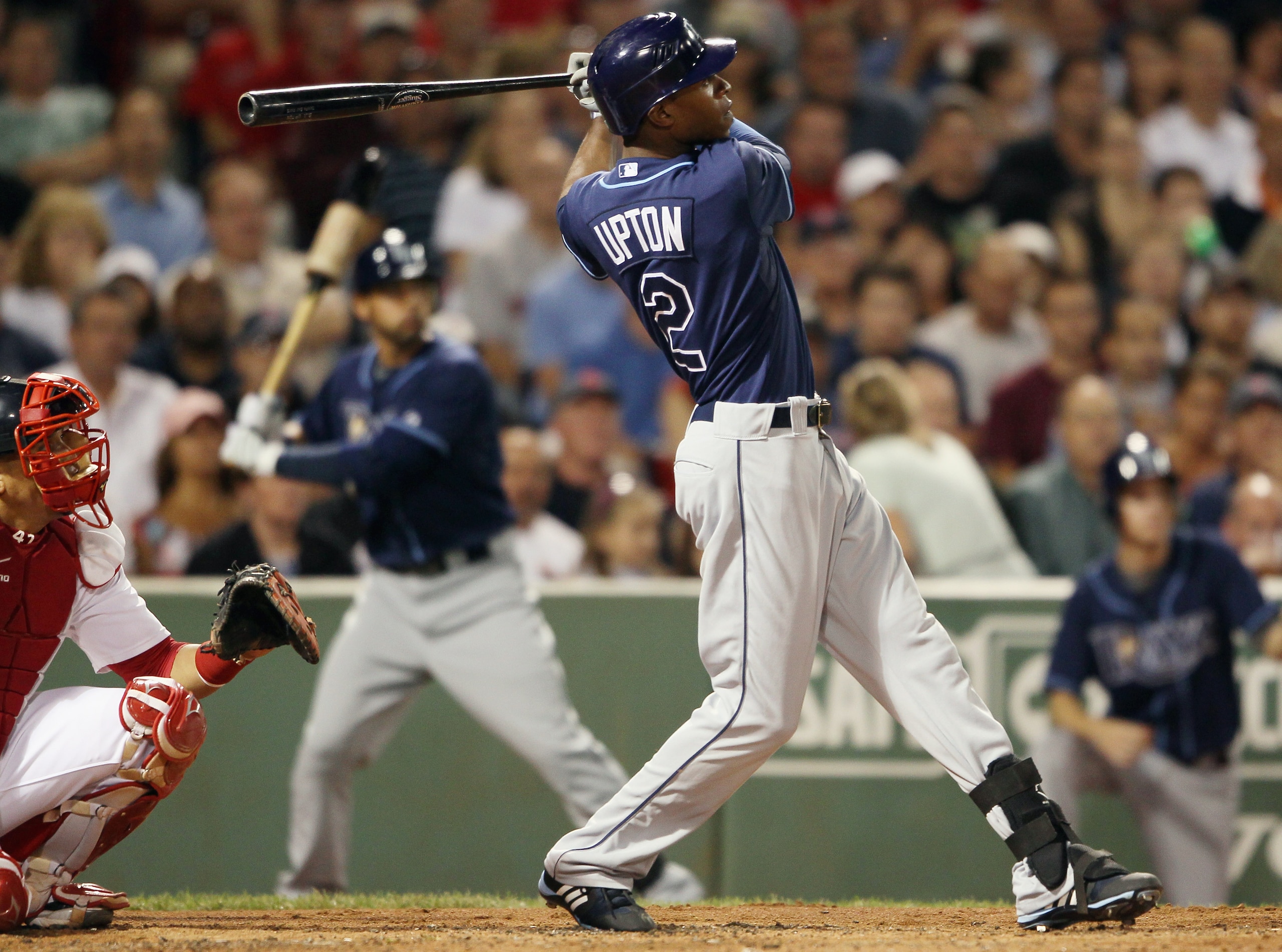 BOSTON - SEPTEMBER 08:  B.J. Upton #2 of the Tampa Bay Rays hits a three run homer in the second inning as Victor Martinez #41 of the Boston Red Sox defends on September 8, 2010 at Fenway Park in Boston, Massachusetts.  (Photo by Elsa/Getty Images)