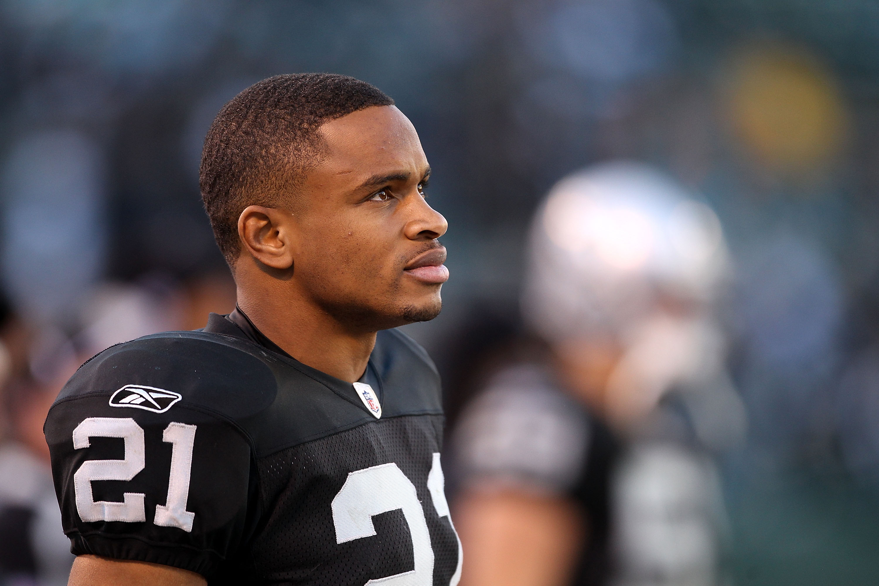 OAKLAND, CA - NOVEMBER 28:  Nnamdi Asomugha #21 of the Oakland Raiders stands on the sidelines during the closing minutes of their loss to the Miami Dolphins at Oakland-Alameda County Coliseum on November 28, 2010 in Oakland, California.  (Photo by Ezra S