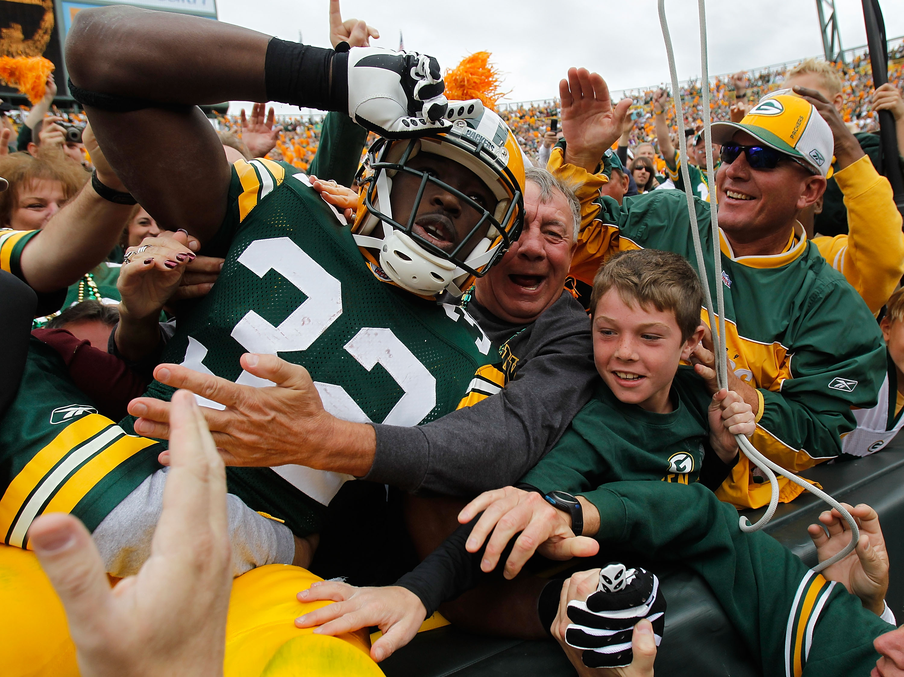 GREEN BAY, WI - SEPTEMBER 19: Brandon Jackson #32 of the Green Bay Packers celebrates a touchdown with a 'Lambeau Leap' into the stands against of the Buffalo Bills at Lambeau Field on September 19, 2010 in Green Bay, Wisconsin. The Packers defeated the B
