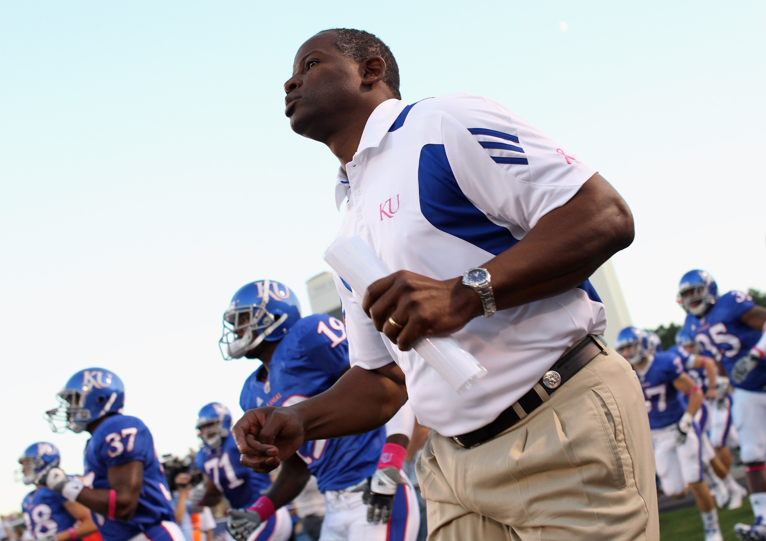 LAWRENCE, KS - OCTOBER 14:  Head coach Turner Gill of the Kansas Jayhawks trots onto the field ahead of the game against the Kansas State Wildcats on October 14, 2010 at Memorial Stadium in Lawrence, Kansas.  (Photo by Jamie Squire/Getty Images)