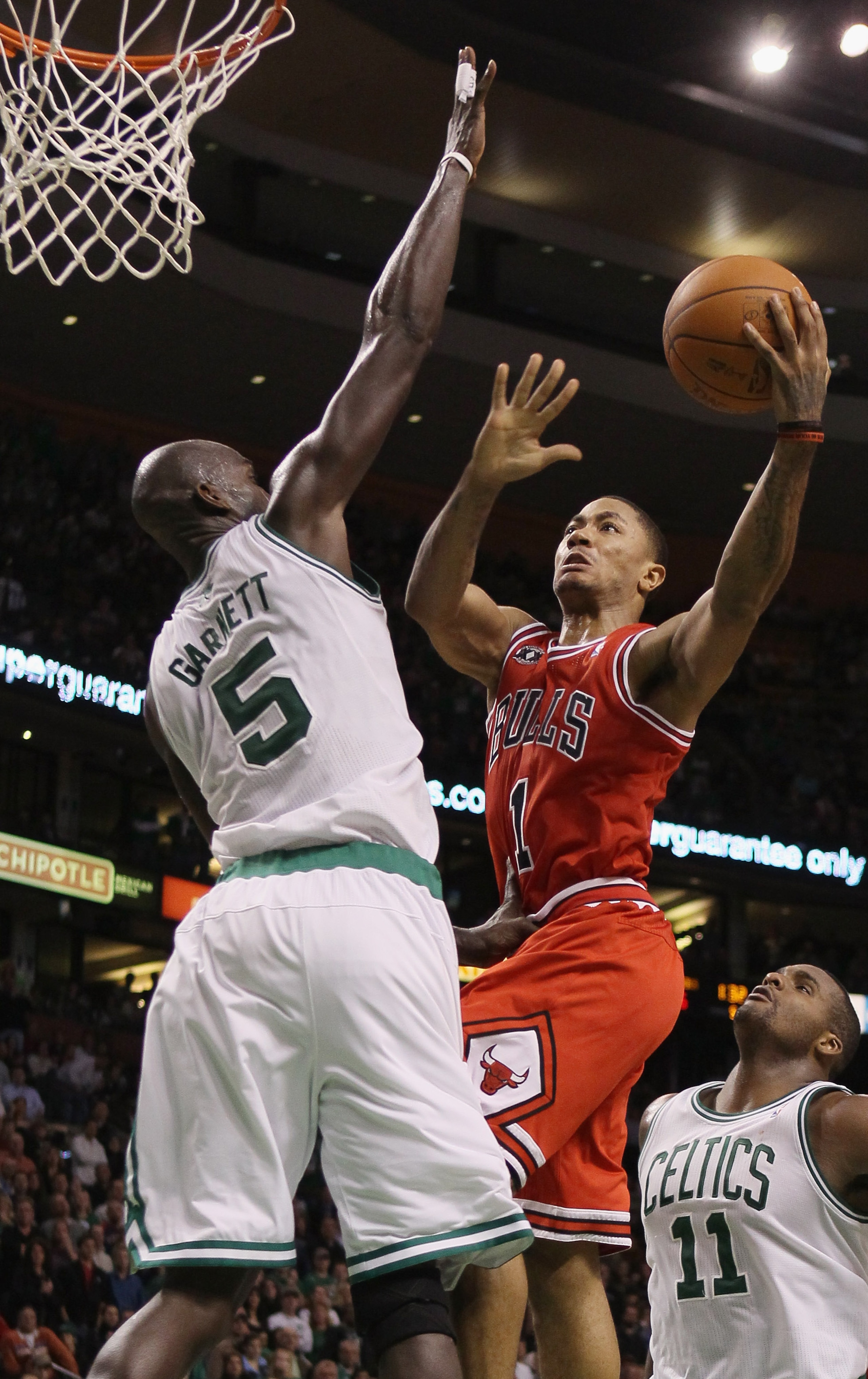 BOSTON - NOVEMBER 05: Derrick Rose #1 of the Chicago Bulls takes a shot as Kevin Garnett #5 of the Boston Celtics on November 5, 2010 at the TD Garden in Boston, Massachusetts. The Celtics defeated the Bulls 110-105 in overtime. NOTE TO USER: User expres BOSTON - NOVEMBER 05: Derrick Rose #1 of the Chicago Bulls takes a shot as Kevin Garnett #5 of the Boston Celtics on November 5, 2010 at the TD Garden in Boston, Massachusetts. The Celtics defeated the Bulls 110-105 in overtime. NOTE TO USER: User expres