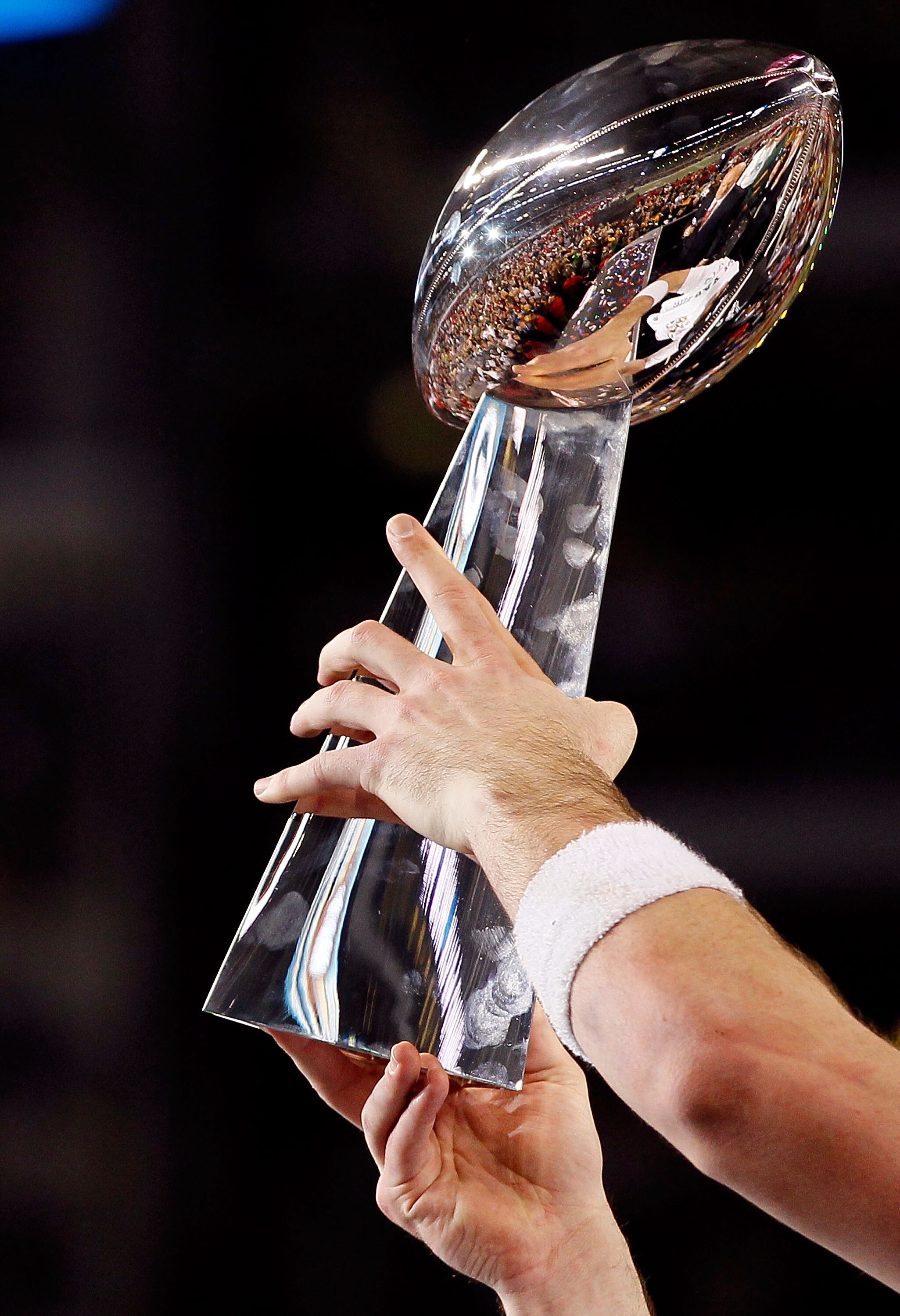 ARLINGTON, TX - FEBRUARY 06:  Quarterback Aaron Rodgers #12 of the Green Bay Packers holds up the VInce Lombardi trophy after the Packers won 31-25 against the Pittsburgh Steelers during Super Bowl XLV at Cowboys Stadium on February 6, 2011 in Arlington,