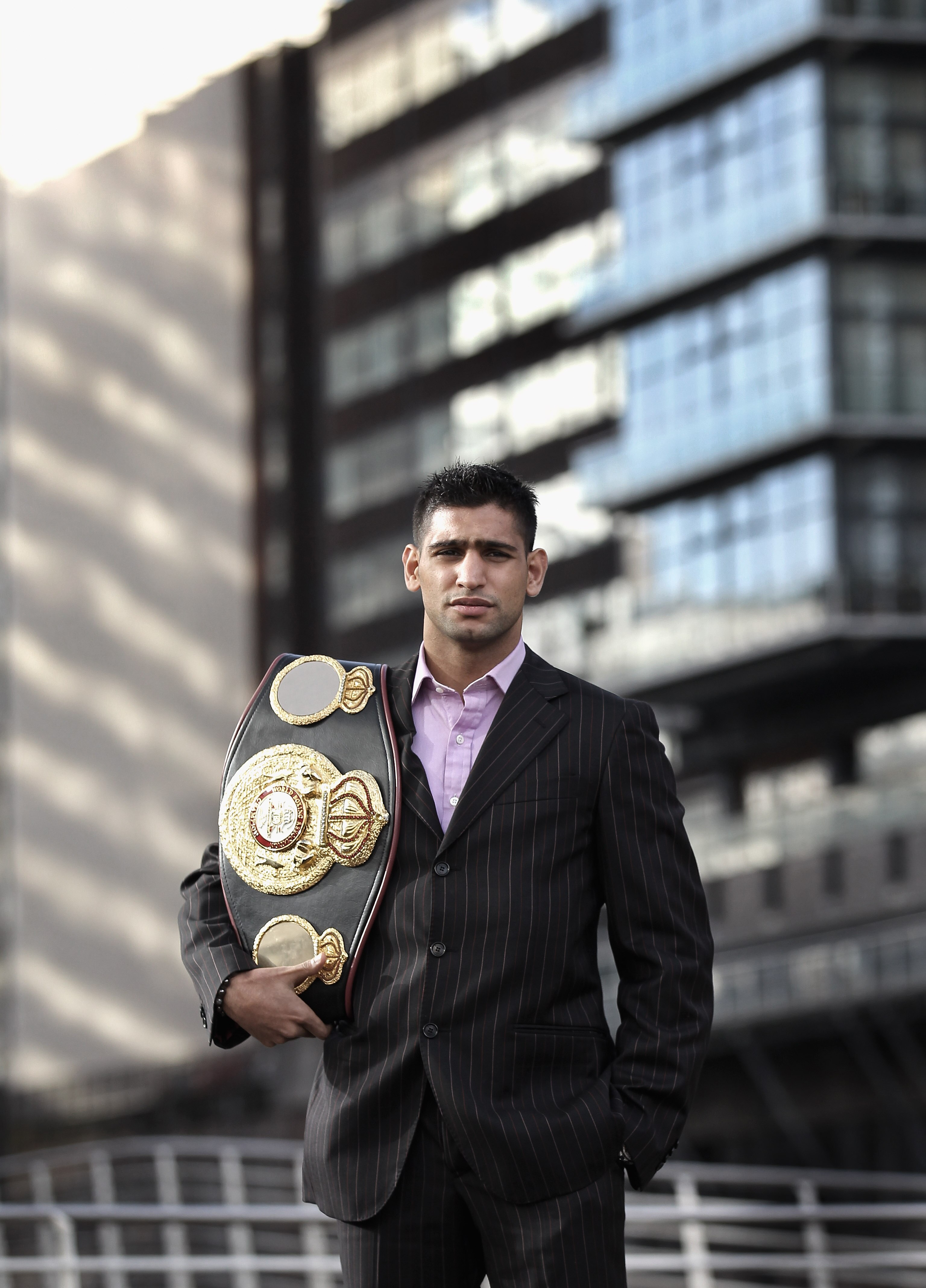 MANCHESTER, ENGLAND - FEBRUARY 08:  (EDITORS NOTE: Image has been desaturated) Amir Khan poses with his WBA light-welterweight belt as he announces his next defence of the title against Paul McCloskey at a photocall at the Lowery Hotel on February 8, 2011