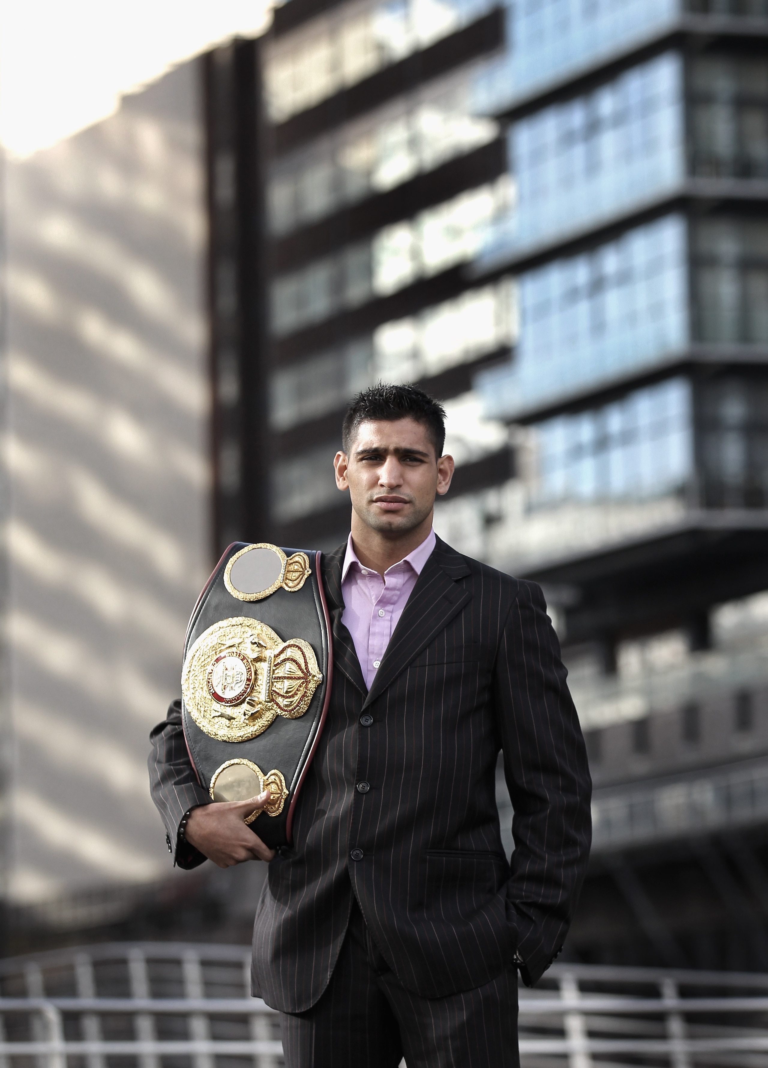 MANCHESTER, ENGLAND - FEBRUARY 08:  (EDITORS NOTE: Image has been desaturated) Amir Khan poses with his WBA light-welterweight belt as he announces his next defence of the title against Paul McCloskey at a photocall at the Lowery Hotel on February 8, 2011