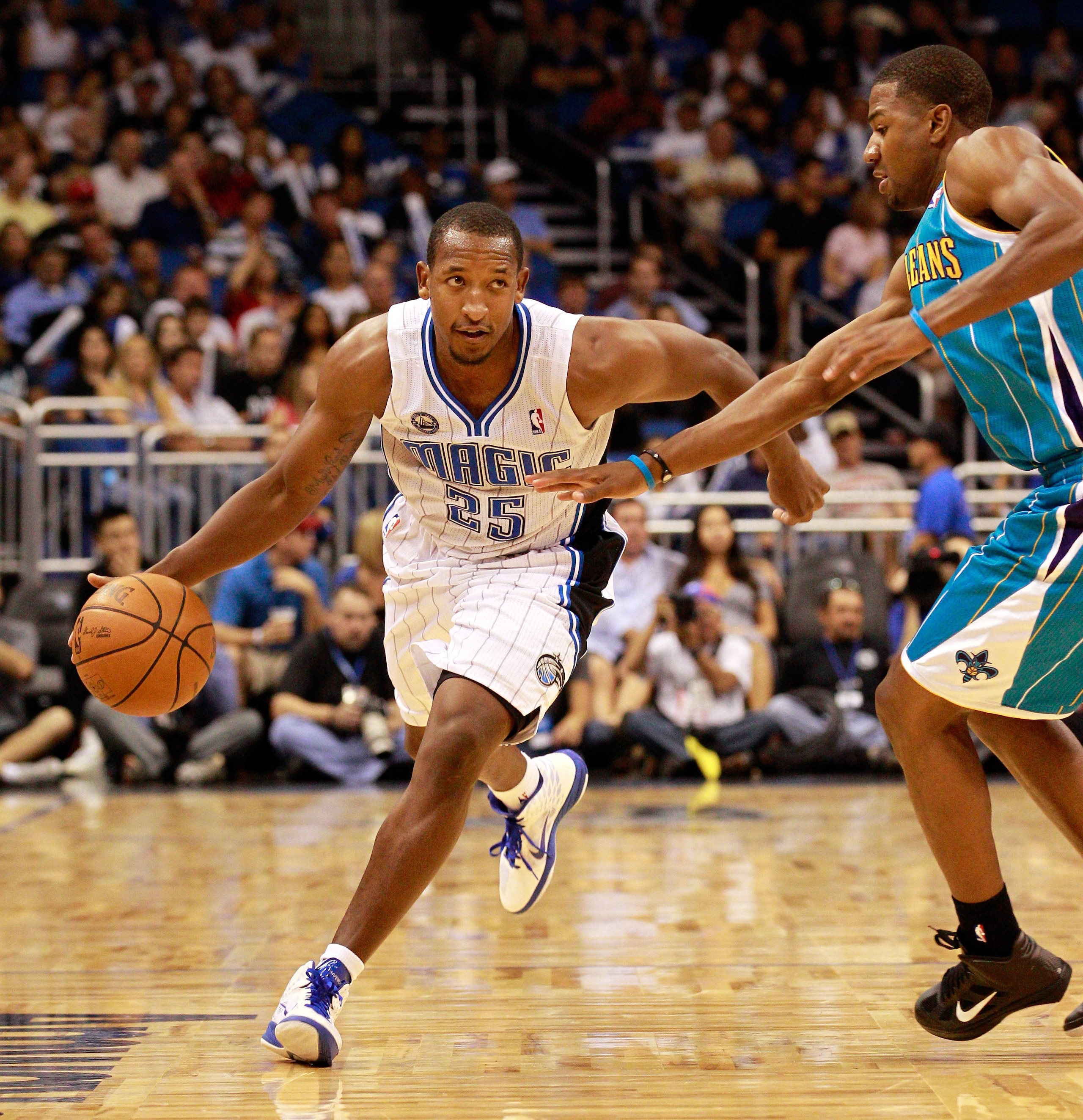 ORLANDO, FL - OCTOBER 10:  Chris Duhon #25 of the Orlando Magic drives against Marcus Thornton #5 of the New Orleans Hornets during the game at Amway Arena on October 10, 2010 in Orlando, Florida. NOTE TO USER: User expressly acknowledges and agrees that,