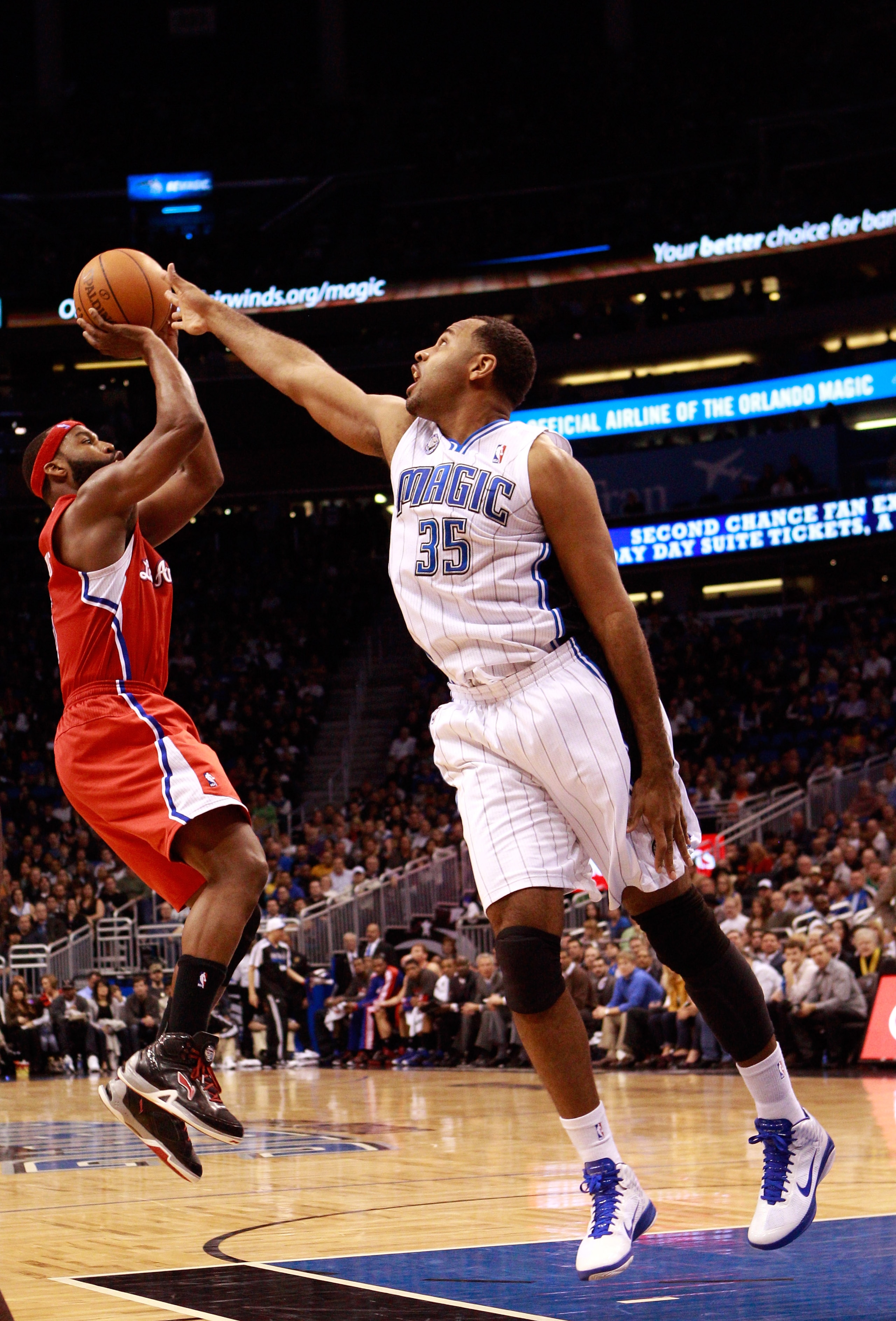 ORLANDO, FL - FEBRUARY 08:  Baron Davis #5 of the Los Angeles Clippers attempts a shot against Malik Allen #35 of the Orlando Magic during the game at Amway Arena on February 8, 2011 in Orlando, Florida.  NOTE TO USER: User expressly acknowledges and agre
