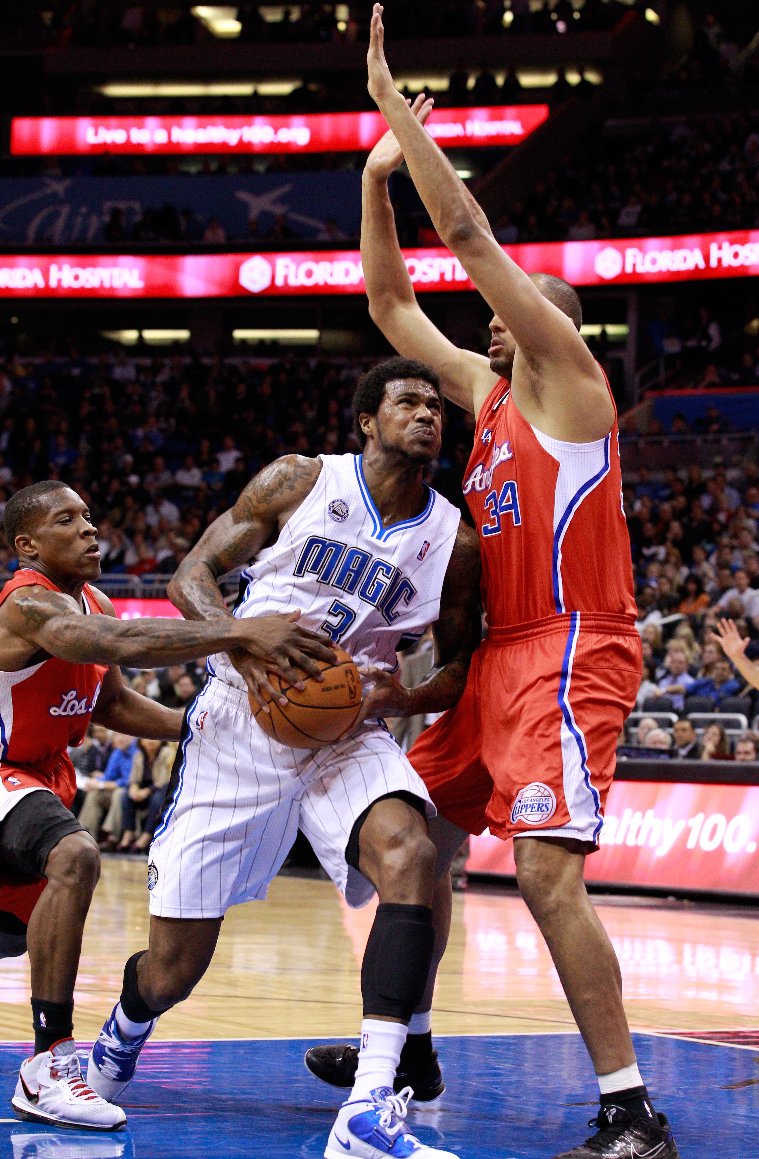 ORLANDO, FL - FEBRUARY 08:  Earl Clark #3 of the Orlando Magic attempts a shot against Brian Cook #34 of the Los Angeles Clippers during the game at Amway Arena on February 8, 2011 in Orlando, Florida.  NOTE TO USER: User expressly acknowledges and agrees