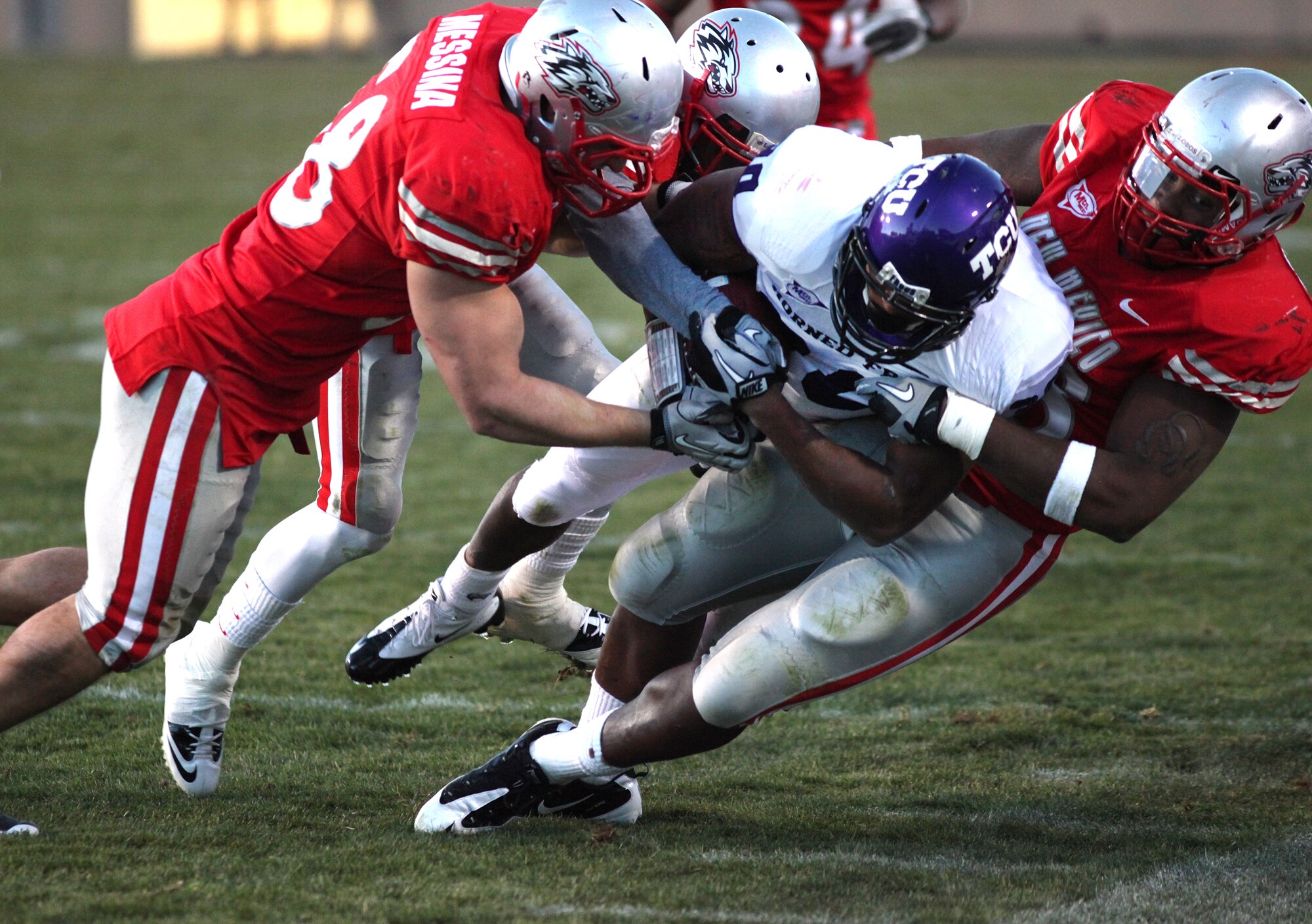 ALBUQUERQUE, NM - NOVEMBER 27: Aundre Dean #30 of the TCU Horned Frogs carries the ball against Carmen Messina #58 (L) and Jaymar Latchison #48 of the New Mexico Lobos in the 3rd quarter on November 27, 2010 at University Stadium in Albuquerque, New Mexic ALBUQUERQUE, NM - NOVEMBER 27: Aundre Dean #30 of the TCU Horned Frogs carries the ball against Carmen Messina #58 (L) and Jaymar Latchison #48 of the New Mexico Lobos in the 3rd quarter on November 27, 2010 at University Stadium in Albuquerque, New Mexic