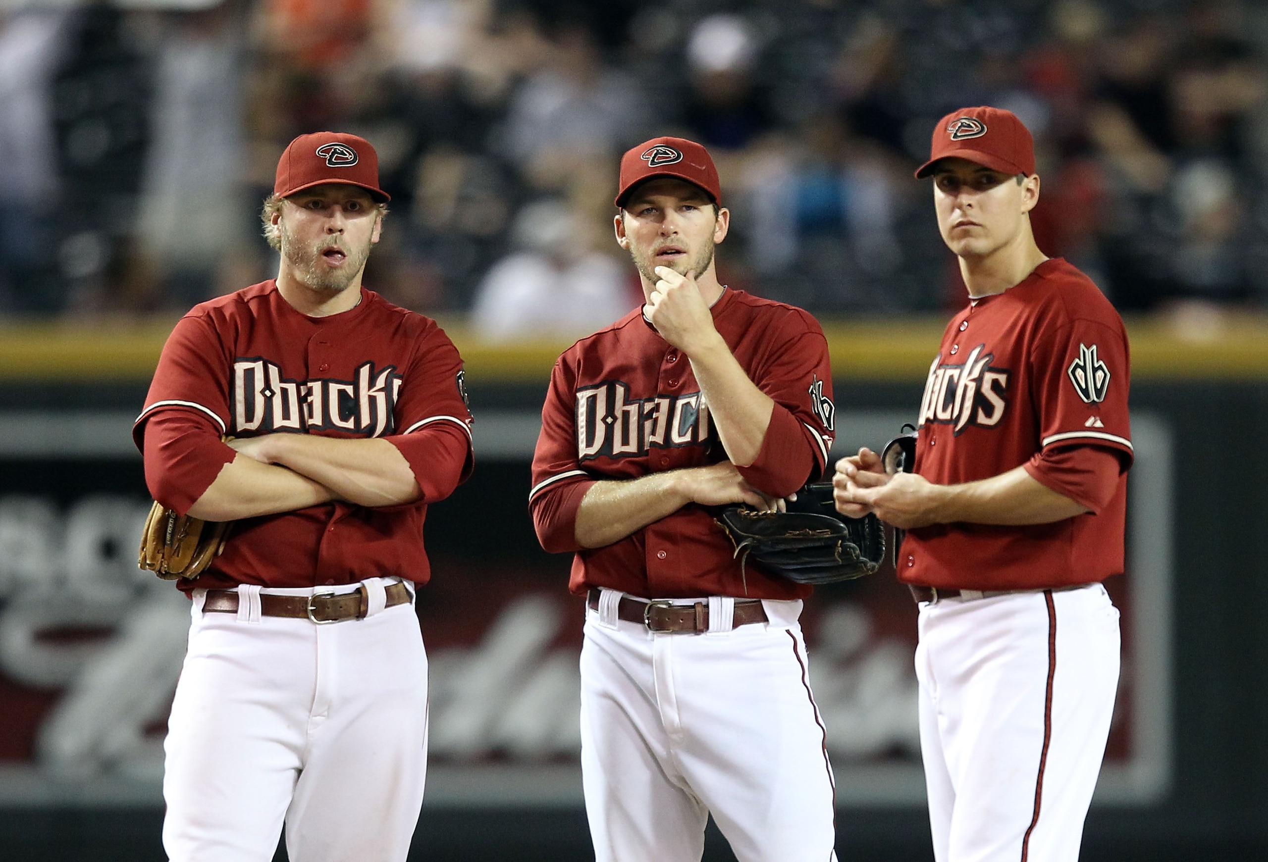 PHOENIX - SEPTEMBER 22:  Inifleders Mark Reynolds #27, Stephen Drew #6 and Kelly Johnson #2 of the Arizona Diamondbacks during the Major League Baseball game against the Colorado Rockies at Chase Field on September 22, 2010 in Phoenix, Arizona.  (Photo by