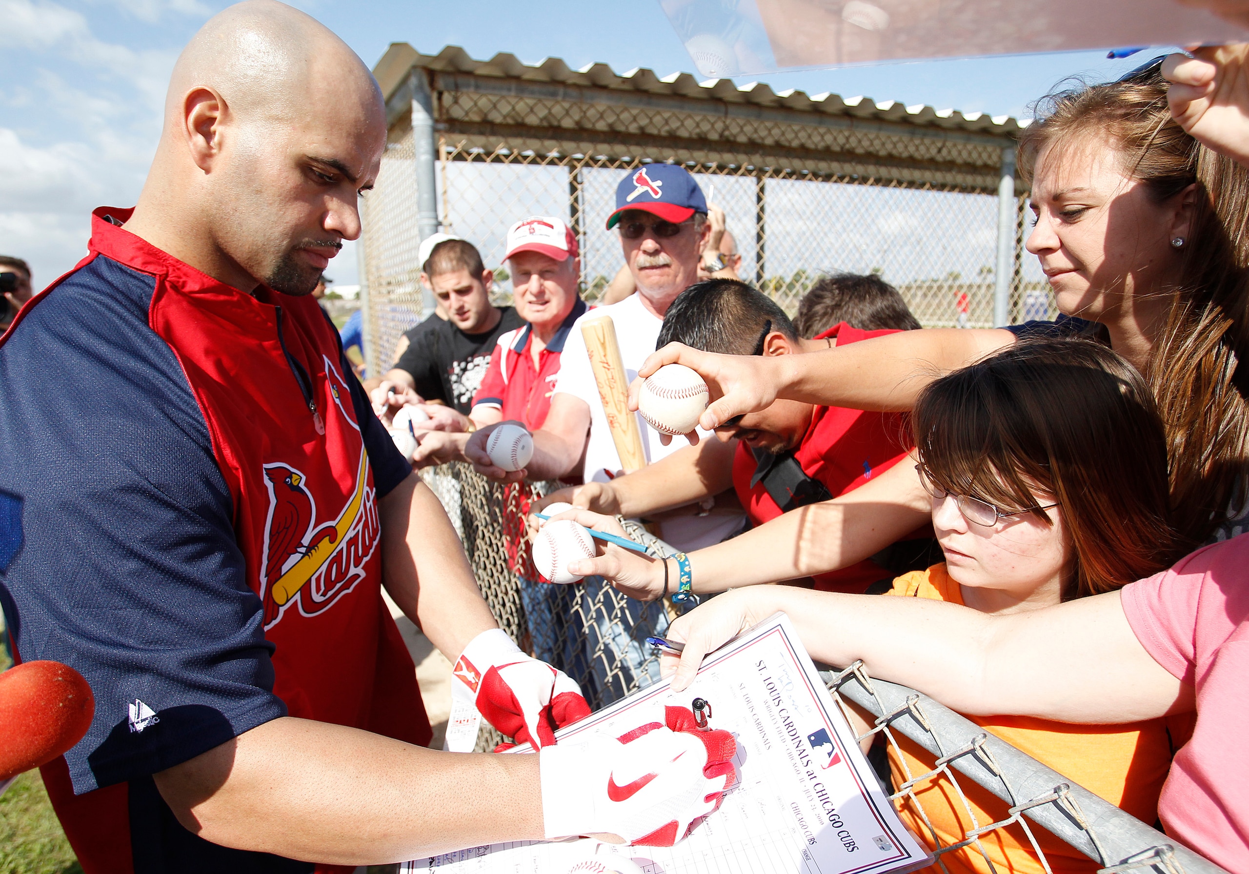 JUPITER, FL - FEBRUARY 17: Albert Pujols #5 #5 of the St. Louis Cardinals signs autographs for fans at Roger Dean Stadium on February 17, 2011 in Jupiter, Florida. (Photo by Joel Auerbach/Getty Images)