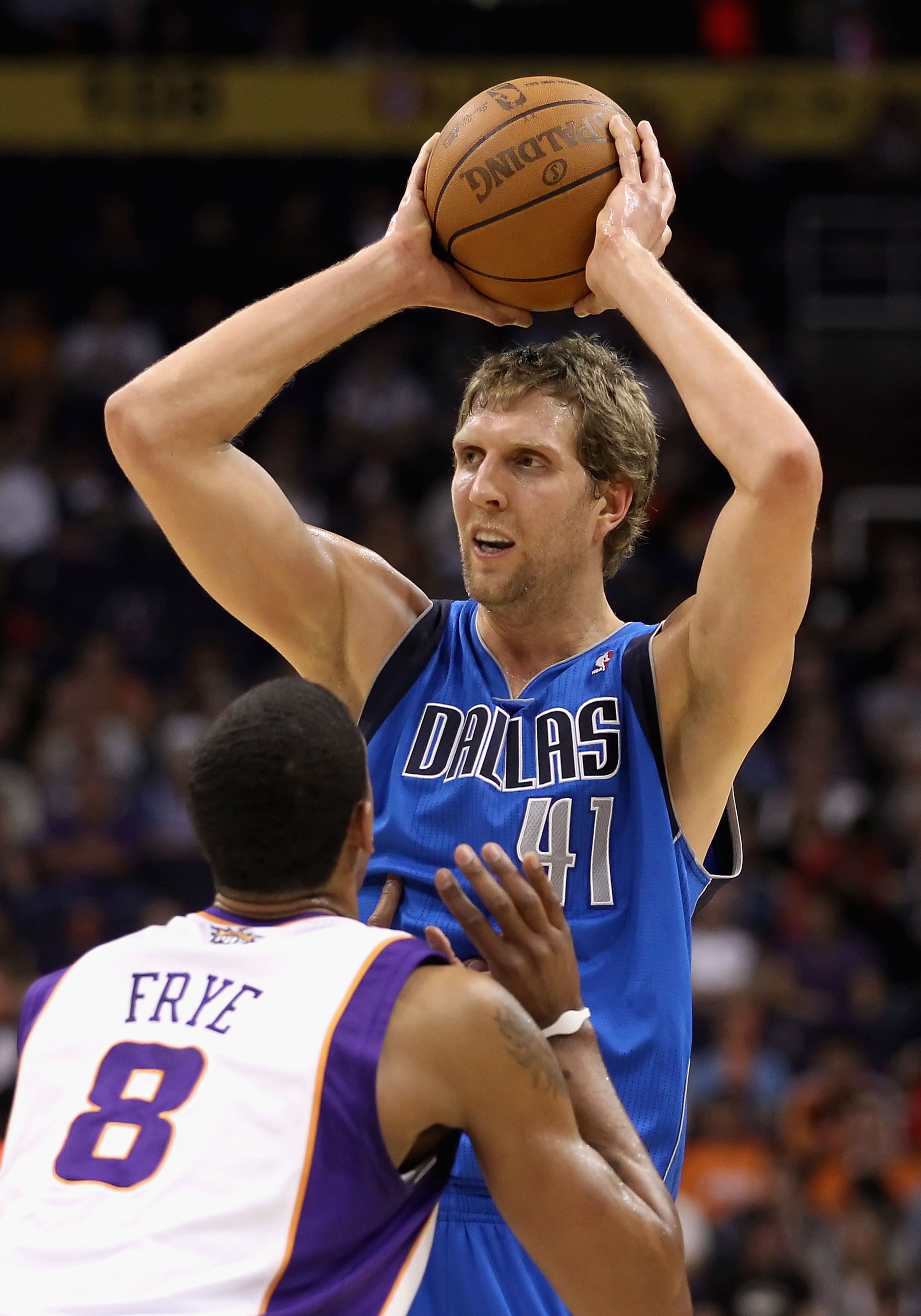 PHOENIX, AZ - FEBRUARY 17:  Dirk Nowitzki #41 of the Dallas Mavericks looks to pass around Channing Frye #8 of the Phoenix Suns during the NBA game at US Airways Center on February 17, 2011 in Phoenix, Arizona.  The Mavericks defeated the Suns 112-106. NO