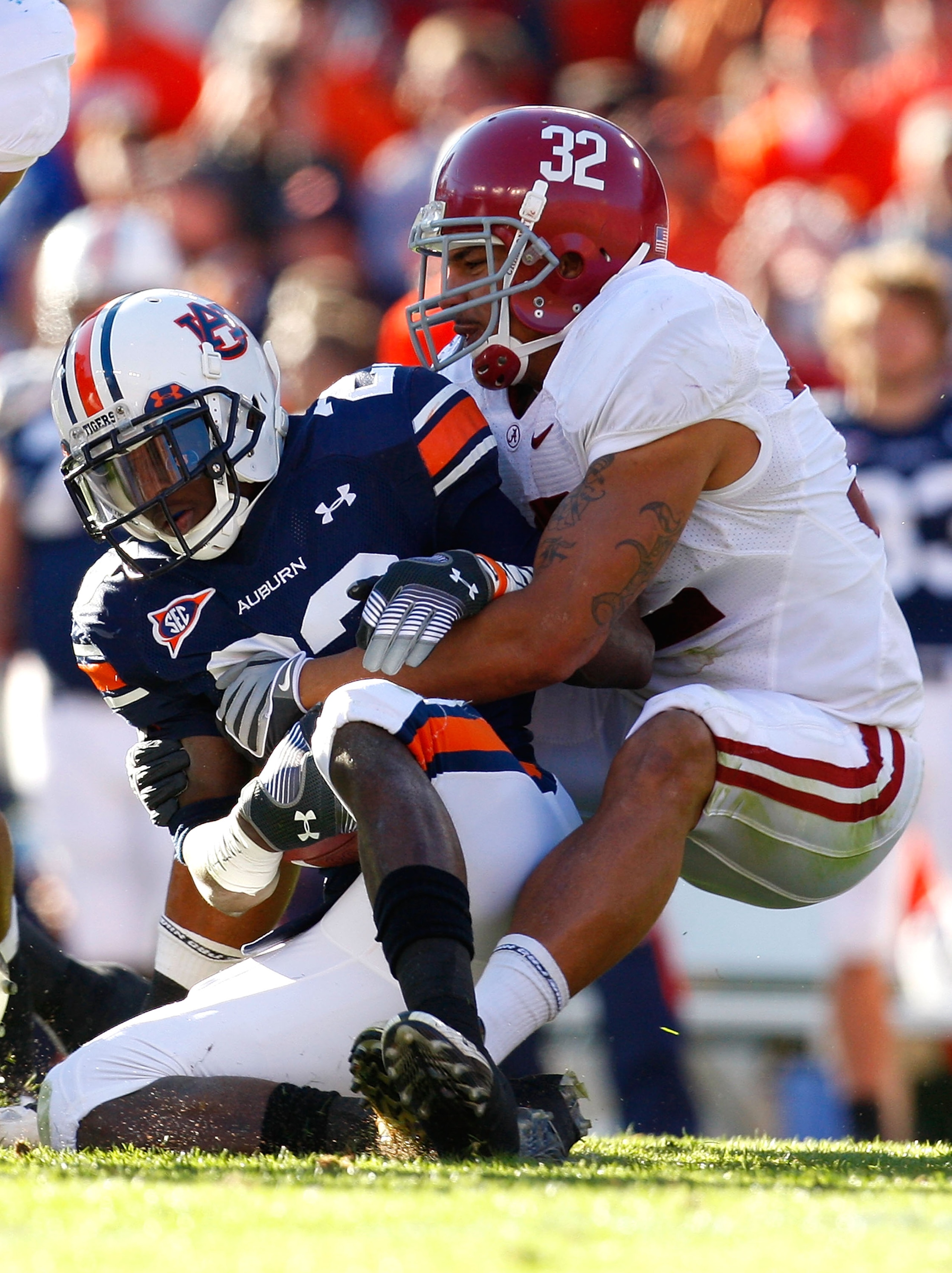 AUBURN, AL - NOVEMBER 27:  Eryk Anders #32 of the Alabama Crimson Tide tackles Onterio McCalebb #23 of the Auburn Tigers at Jordan-Hare Stadium on November 27, 2009 in Auburn, Alabama.  (Photo by Kevin C. Cox/Getty Images)