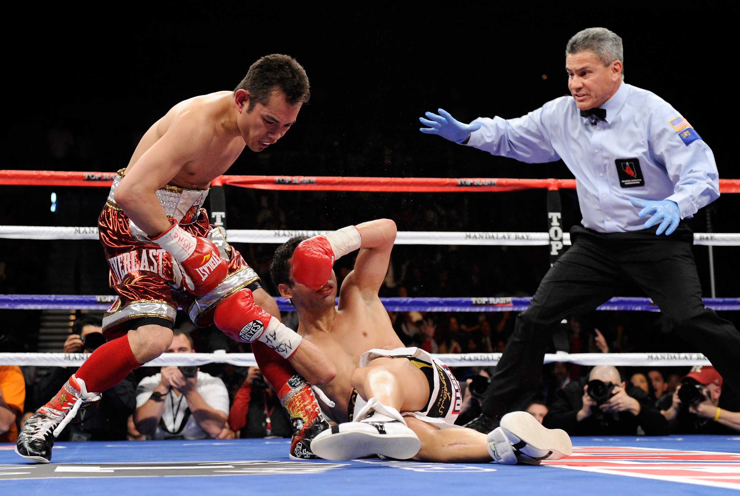 LAS VEGAS, NV - FEBRUARY 19:  (L-R) Nonito Donaire of the Philippines sends Fernando Montiel of Mexico to the canvas in the second round of their WBC/WBO bantamweight championship bout as referee Russell Mora moves in at the Mandalay Bay Events Center Feb