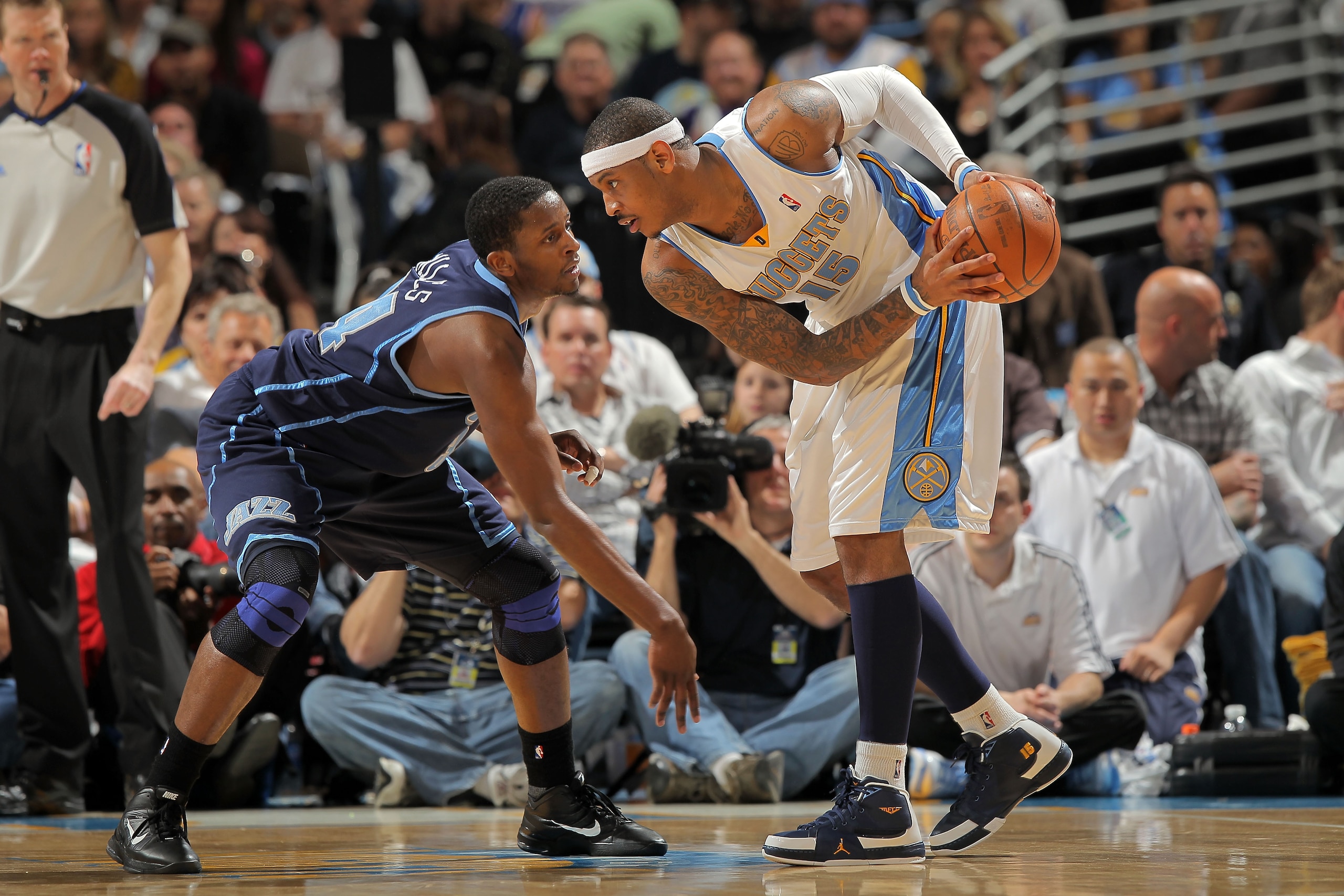 DENVER - APRIL 28: Carmelo Anthony #15 of the Denver Nuggets as C.J. Miles #34 of the Utah Jazz defends in Game Five of the Western Conference Quarterfinals of the 2010 NBA Playoffs at the Pepsi Center on April 28, 2010 in Denver, Colorado. The Nuggets d DENVER - APRIL 28: Carmelo Anthony #15 of the Denver Nuggets as C.J. Miles #34 of the Utah Jazz defends in Game Five of the Western Conference Quarterfinals of the 2010 NBA Playoffs at the Pepsi Center on April 28, 2010 in Denver, Colorado. The Nuggets d