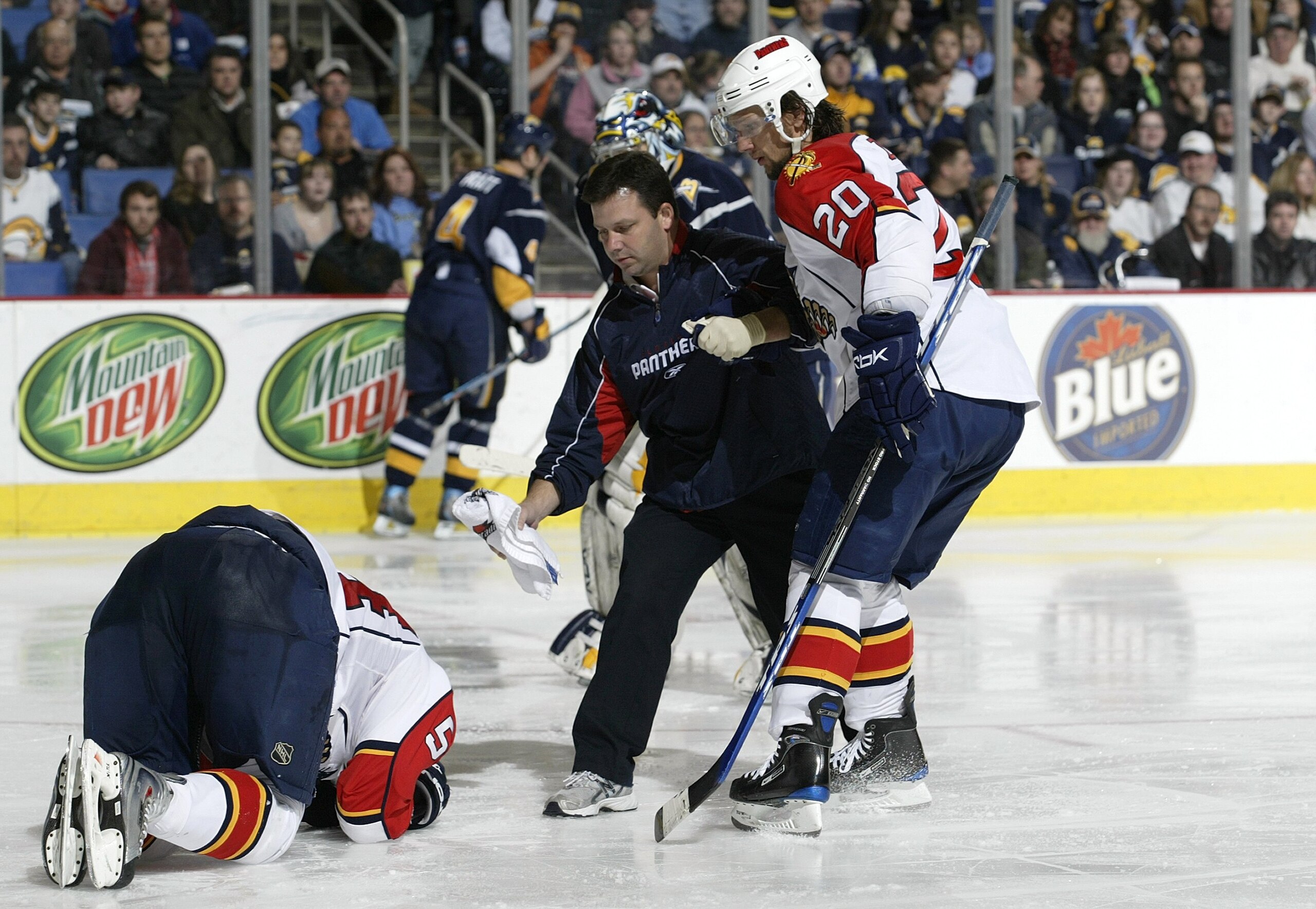 BUFFALO, NY - FEBRUARY 10:  Richard Zednik #20 of the Florida Panthers helps the trainer to teammate Kamil Kreps #54 during a break in NHL game action against the Buffalo Sabres on February 10, 2008 at HSBC Arena in Buffalo, New York. The Sabres defeated 