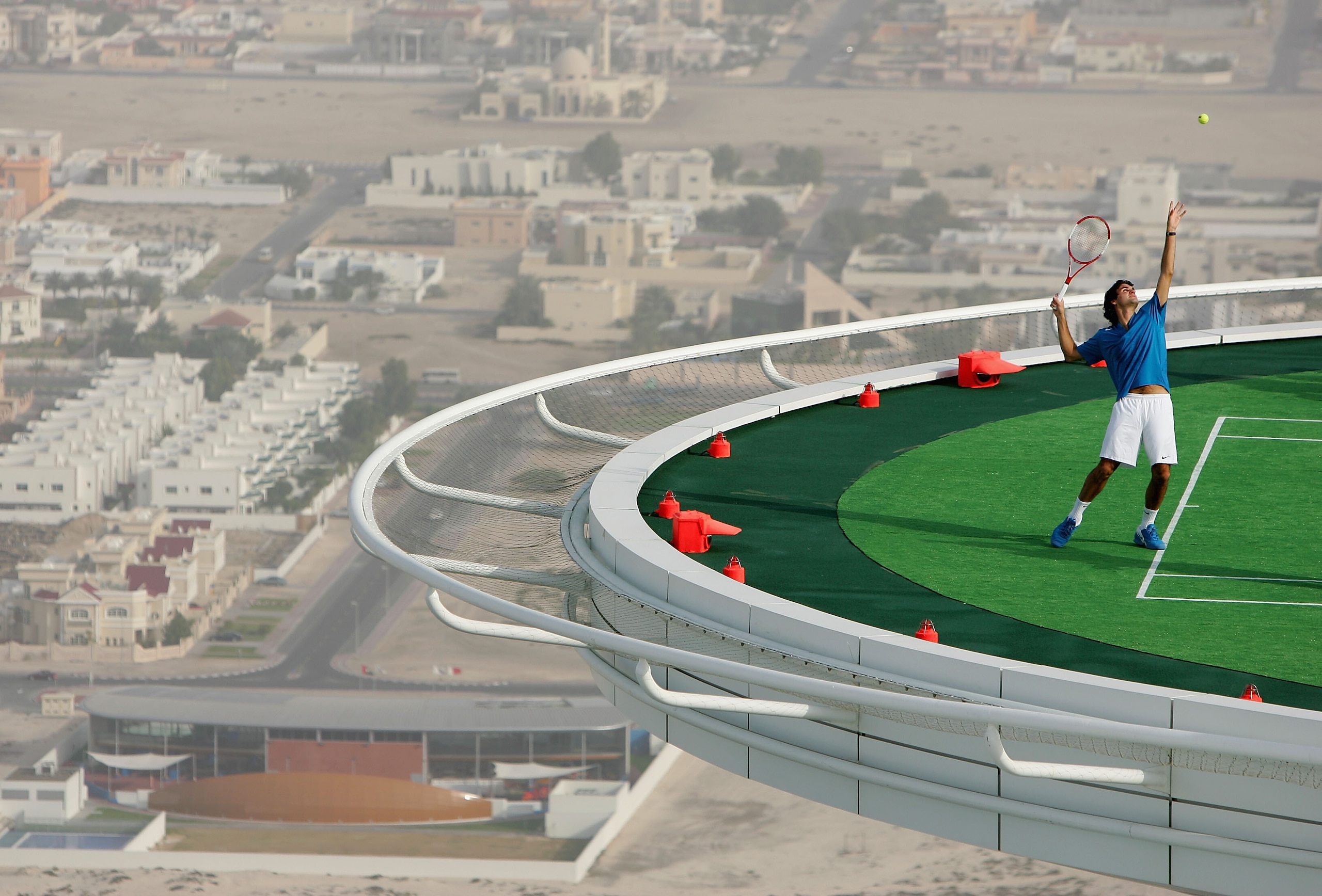 DUBAI, UAE - FEBRUARY 22:  In preparation for the Dubai Duty Free Men's Open, tennis legend Andre Agassi of the USA and the World's No. 1 Roger Federer of Switzerland, couldn't resist the temptation to have a friendly 'hit' on the world's most unique tenn