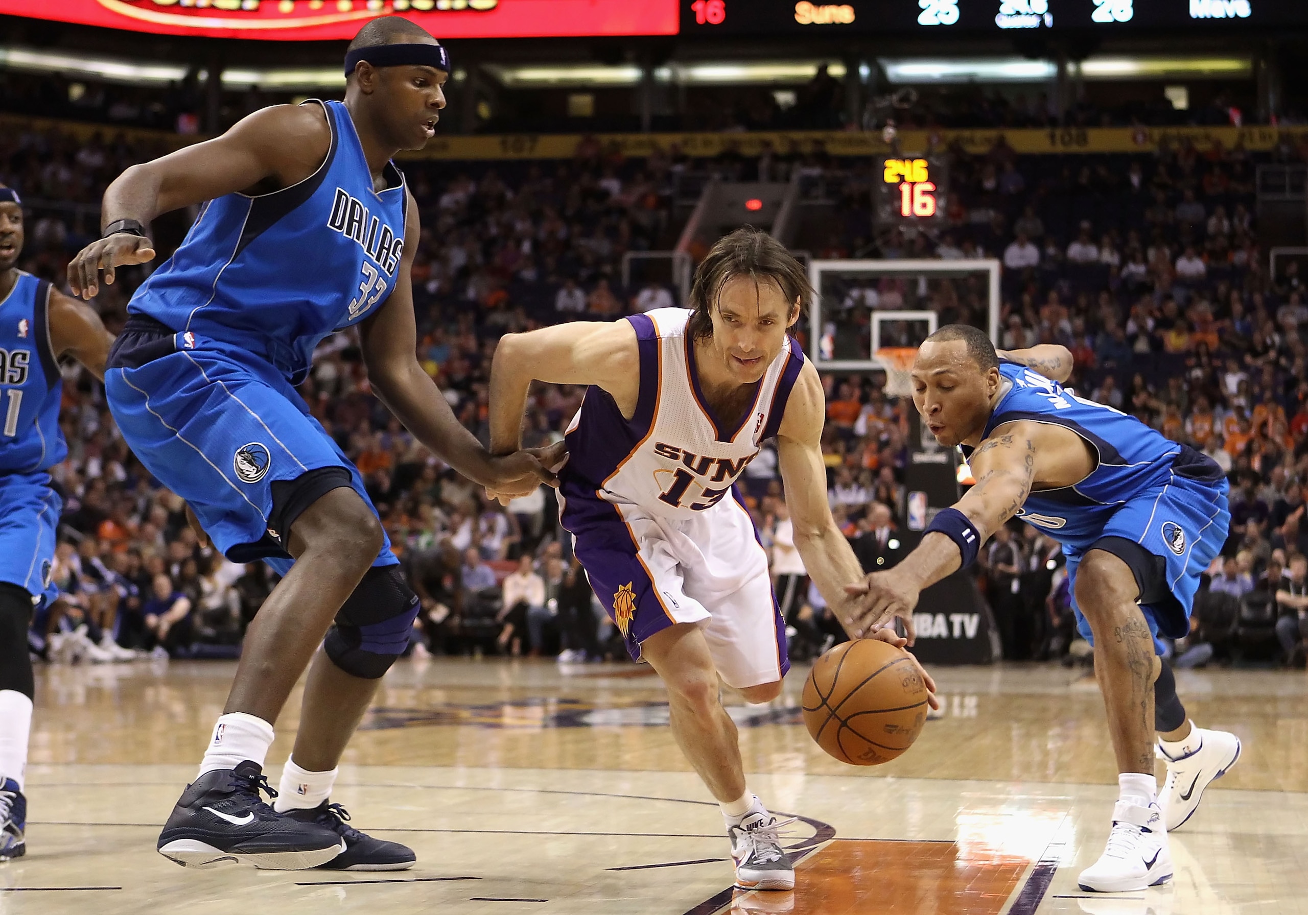 PHOENIX, AZ - FEBRUARY 17: Steve Nash #13 of the Phoenix Suns drives the ball between Brendan Haywood #33 and Shawn Marion #0 of the Dallas Mavericks during the NBA game at US Airways Center on February 17, 2011 in Phoenix, Arizona. NOTE TO USER: User e PHOENIX, AZ - FEBRUARY 17: Steve Nash #13 of the Phoenix Suns drives the ball between Brendan Haywood #33 and Shawn Marion #0 of the Dallas Mavericks during the NBA game at US Airways Center on February 17, 2011 in Phoenix, Arizona. NOTE TO USER: User e