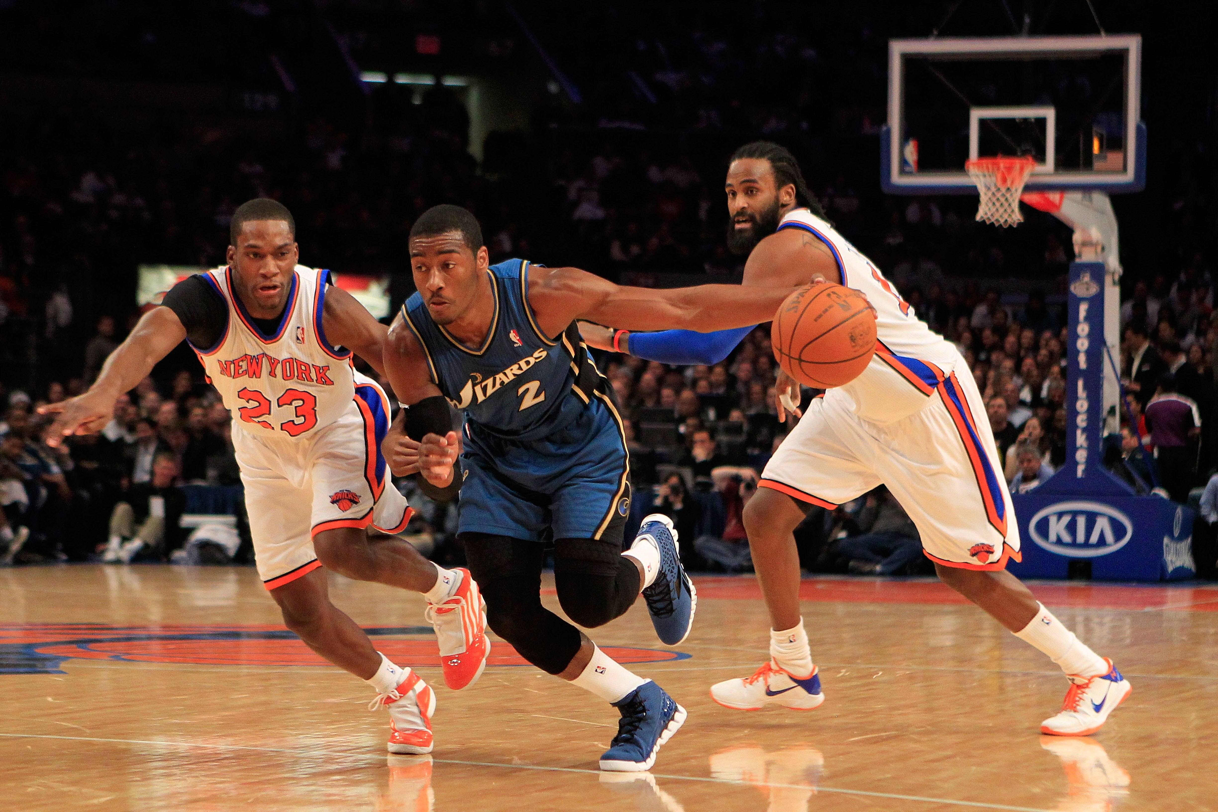 NEW YORK, NY - JANUARY 24: John Wall #2 of the Washington Wizards drives past  Toney Douglas #23 of the New York Knicks at Madison Square Garden on January 24, 2011 in New York City. NOTE TO USER: User expressly acknowledges and agrees that, by downloadin