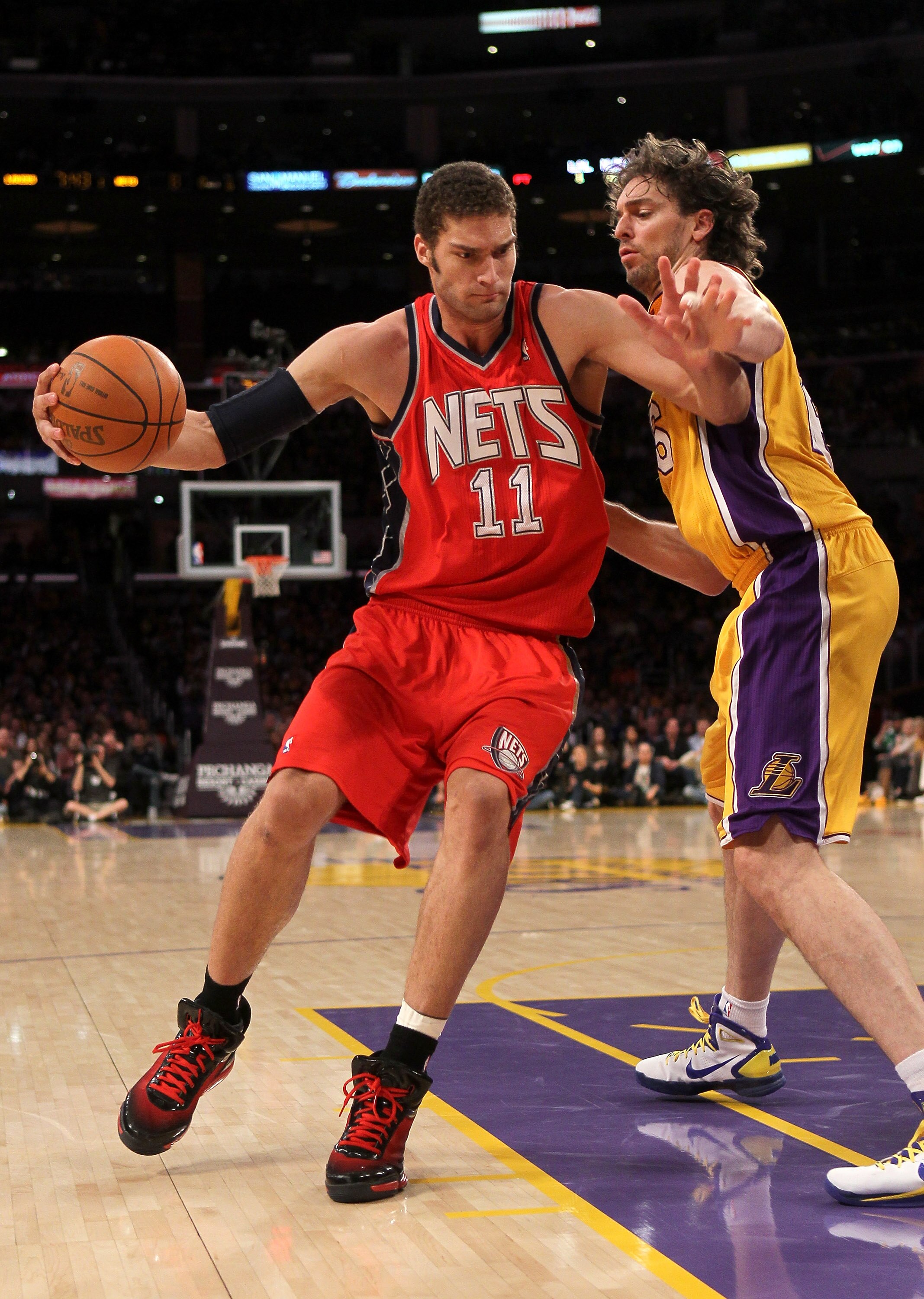 LOS ANGELES, CA - JANUARY 14:  Brook Lopez #11 of the New Jersey Nets drives against Pau Gasol #16 of the Los Angeles Lakers at Staples Center on January 14, 2011 in Los Angeles, California. The Lakers won 100-88.  NOTE TO USER: User expressly acknowledge