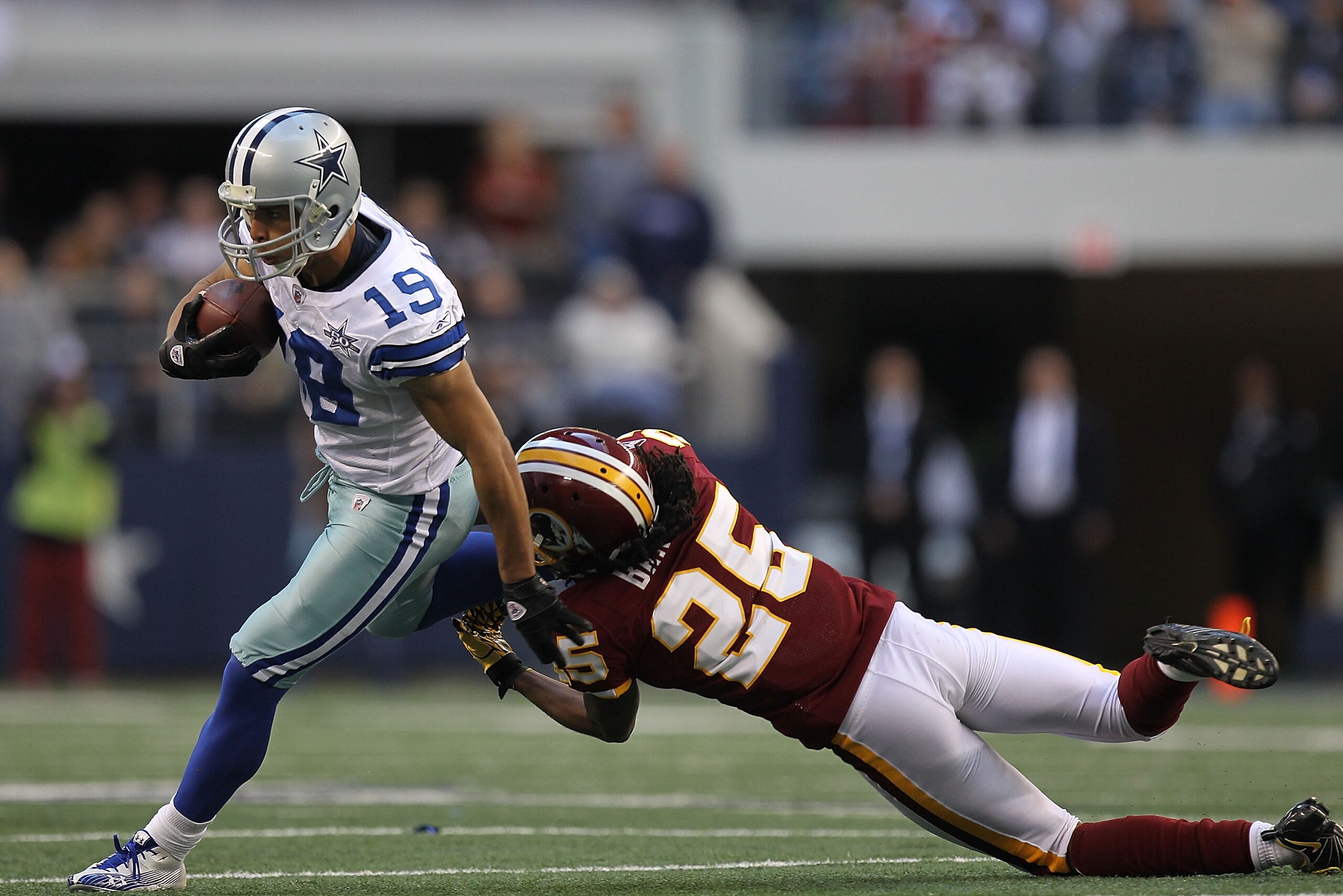 ARLINGTON, TX - DECEMBER 19:  Wide receiver Miles Austin #19 of the Dallas Cowboys runs the ball against Kevin Barnes #25 of the Washington Redskins at Cowboys Stadium on December 19, 2010 in Arlington, Texas.  (Photo by Ronald Martinez/Getty Images)