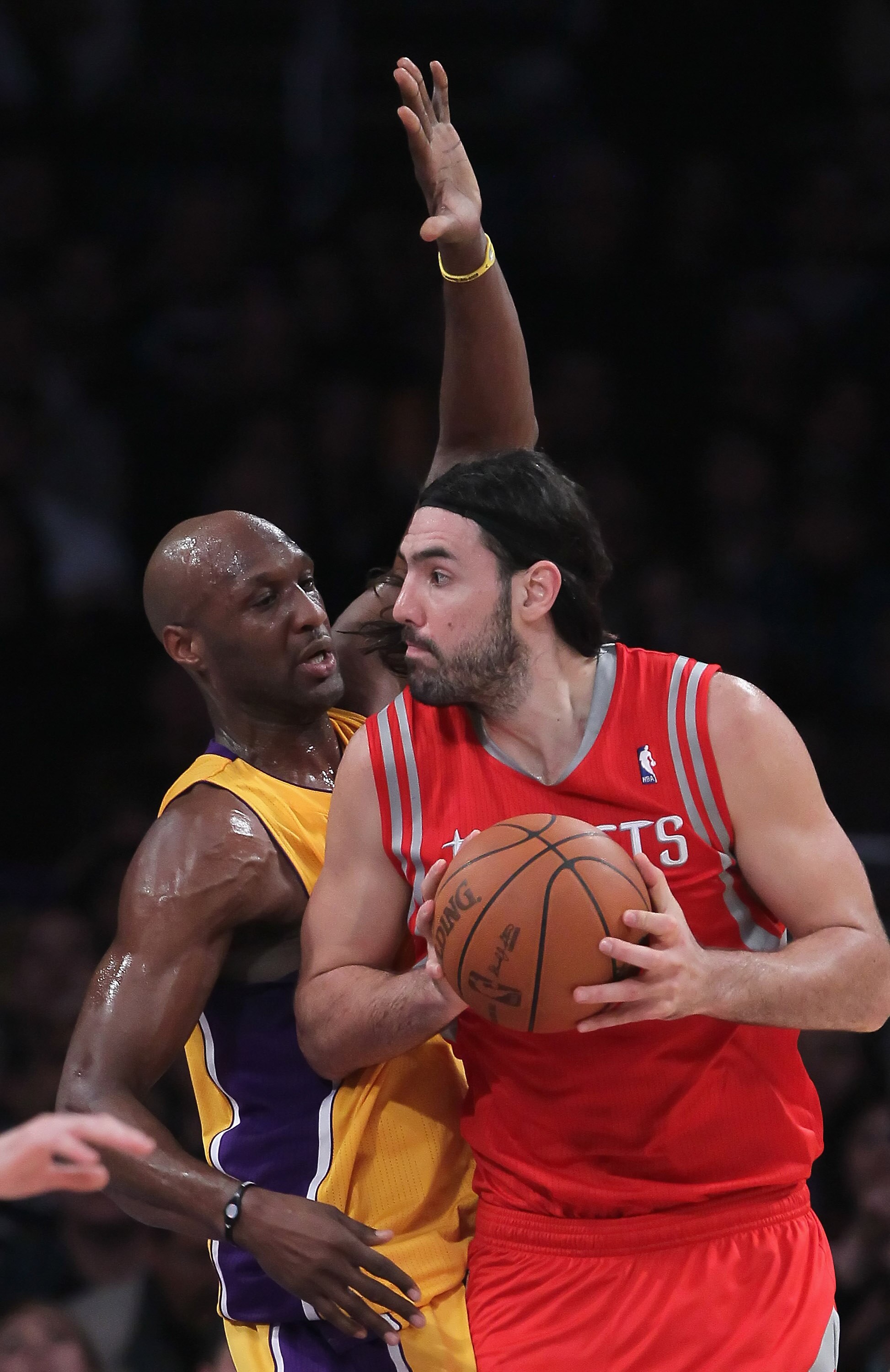 LOS ANGELES, CA - FEBRUARY 01:  Luis Scola #4 of the Houston Rockets is defended by Lamar Odom #7 of the Los Angeles Lakers in the first half at Staples Center on February 1, 2011 in Los Angeles, California. The Lakers defeated the Rockets 114-106. NOTE T