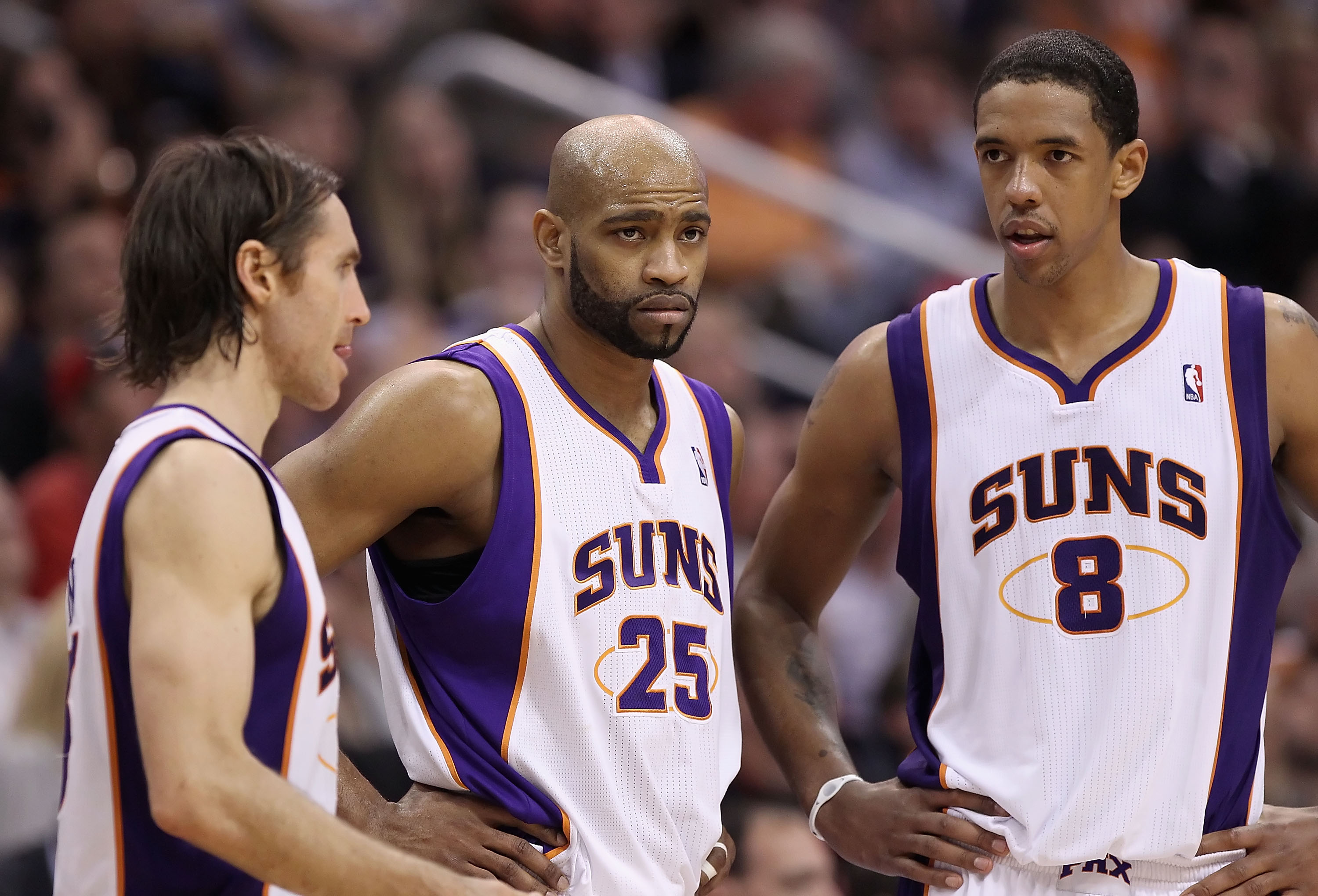 PHOENIX, AZ - FEBRUARY 17:  (L-R) Steve Nash #13, Vince Carter #25 and Channing Frye #8 of the Phoenix Suns react during a break from the NBA game against the Dallas Mavericks at US Airways Center on February 17, 2011 in Phoenix, Arizona.  The Mavericks d