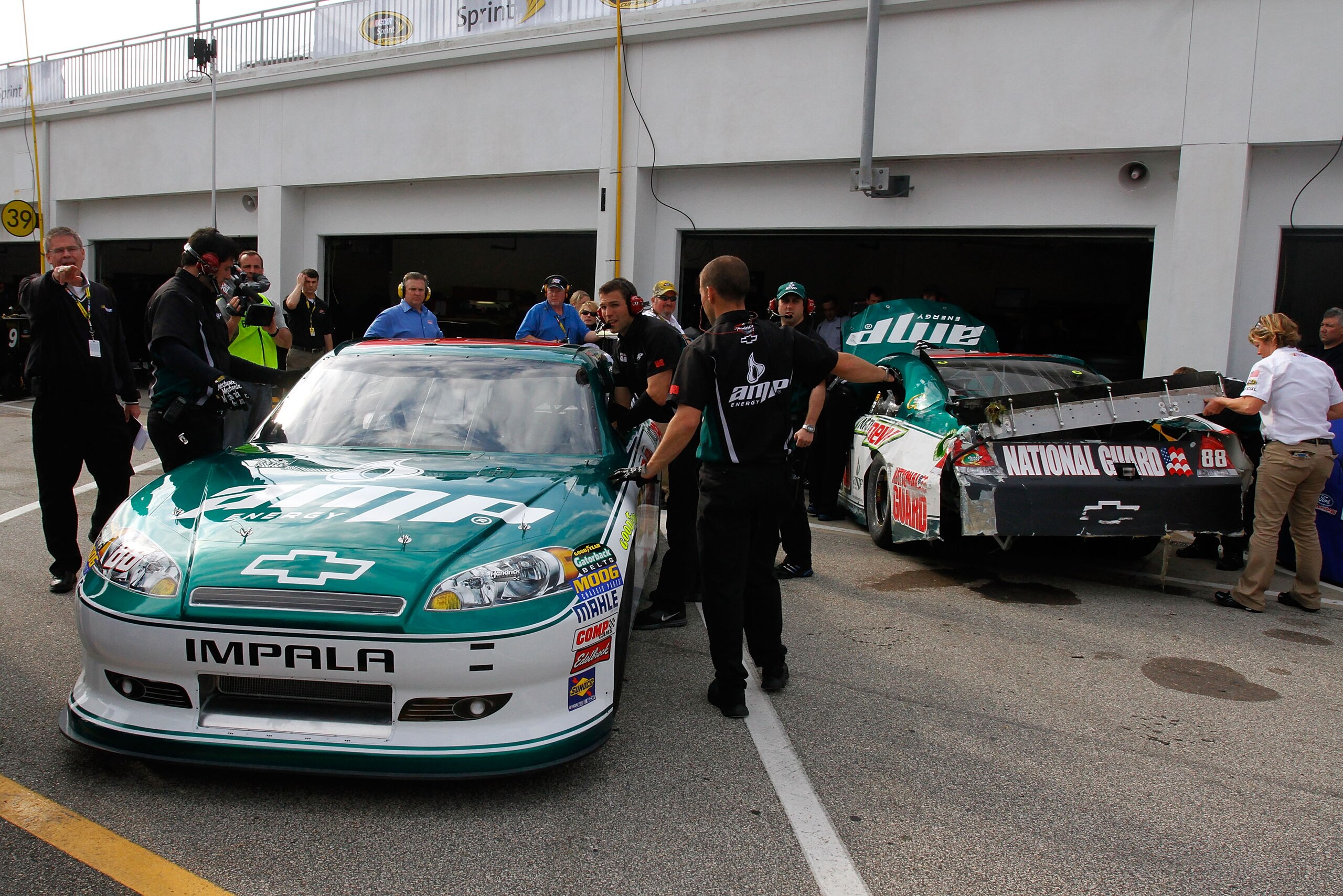 DAYTONA BEACH, FL - FEBRUARY 16: An alternate car for Dale Earnhardt Jr., driver of the #88 National Guard/AMP Energy Chevrolet, sits next to his damaged car in the garage area after an incident in practice for the NASCAR Sprint Cup Series Daytona 500 at DAYTONA BEACH, FL - FEBRUARY 16: An alternate car for Dale Earnhardt Jr., driver of the #88 National Guard/AMP Energy Chevrolet, sits next to his damaged car in the garage area after an incident in practice for the NASCAR Sprint Cup Series Daytona 500 at