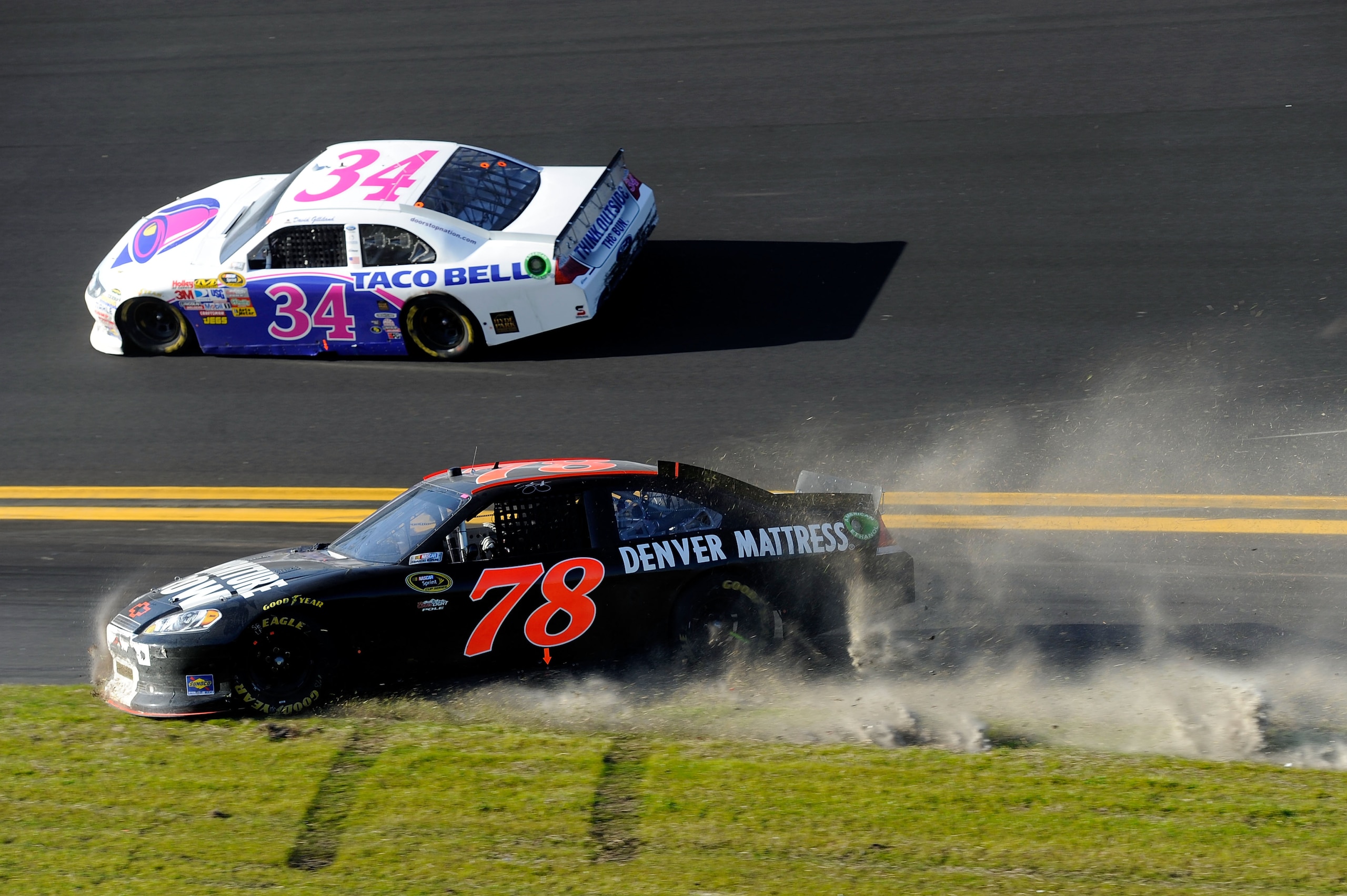 DAYTONA BEACH, FL - FEBRUARY 20: Regan Smith, driver of the #78 Furniture Row Racing Chevrolet, slides on the apron out as David Gilliland, driver of the #34 Taco Bell Ford, passes during the NASCAR Sprint Cup Series Daytona 500 at Daytona International DAYTONA BEACH, FL - FEBRUARY 20: Regan Smith, driver of the #78 Furniture Row Racing Chevrolet, slides on the apron out as David Gilliland, driver of the #34 Taco Bell Ford, passes during the NASCAR Sprint Cup Series Daytona 500 at Daytona International