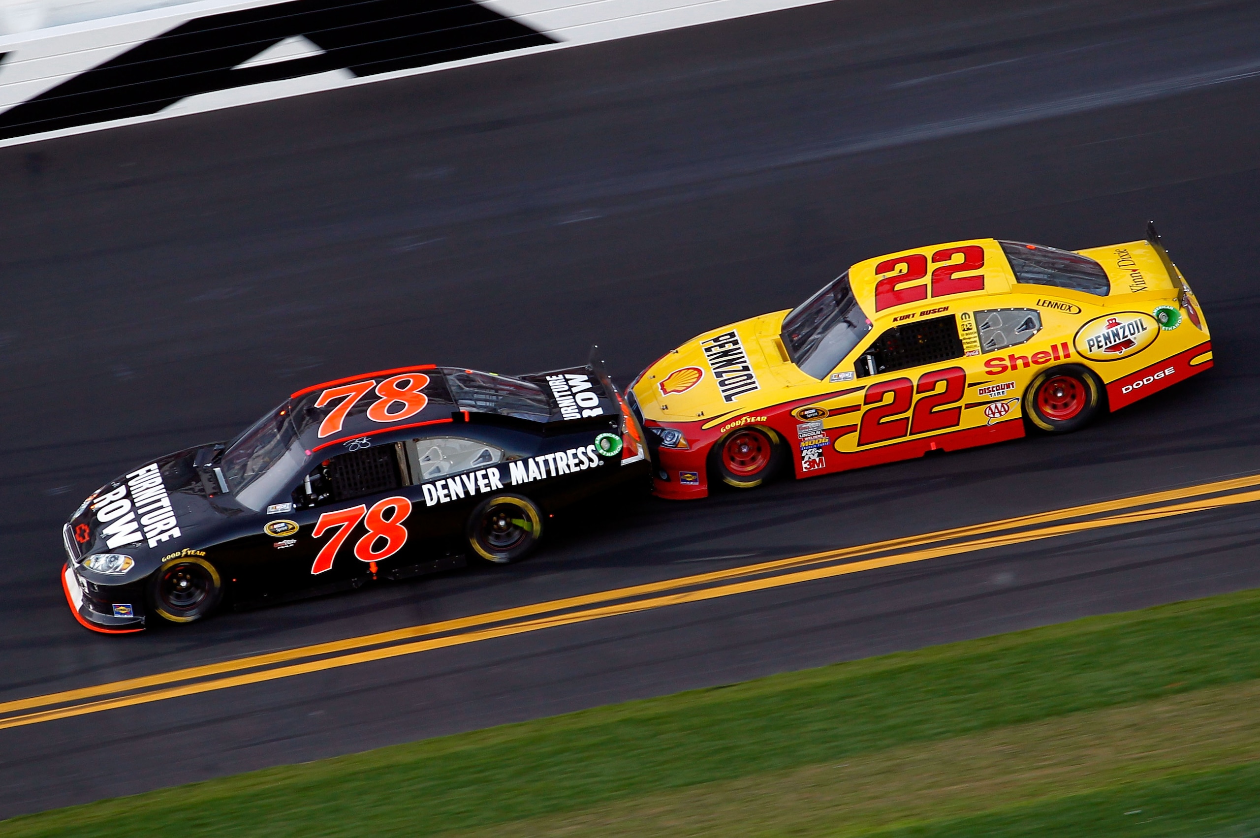 DAYTONA BEACH, FL - FEBRUARY 20: Regan Smith, driver of the #78 Furniture Row Racing Chevrolet, and Kurt Busch, driver of the #22 Shell Pennzoil Dodge, race during the NASCAR Sprint Cup Series Daytona 500 at Daytona International Speedway on February 20 DAYTONA BEACH, FL - FEBRUARY 20: Regan Smith, driver of the #78 Furniture Row Racing Chevrolet, and Kurt Busch, driver of the #22 Shell Pennzoil Dodge, race during the NASCAR Sprint Cup Series Daytona 500 at Daytona International Speedway on February 20
