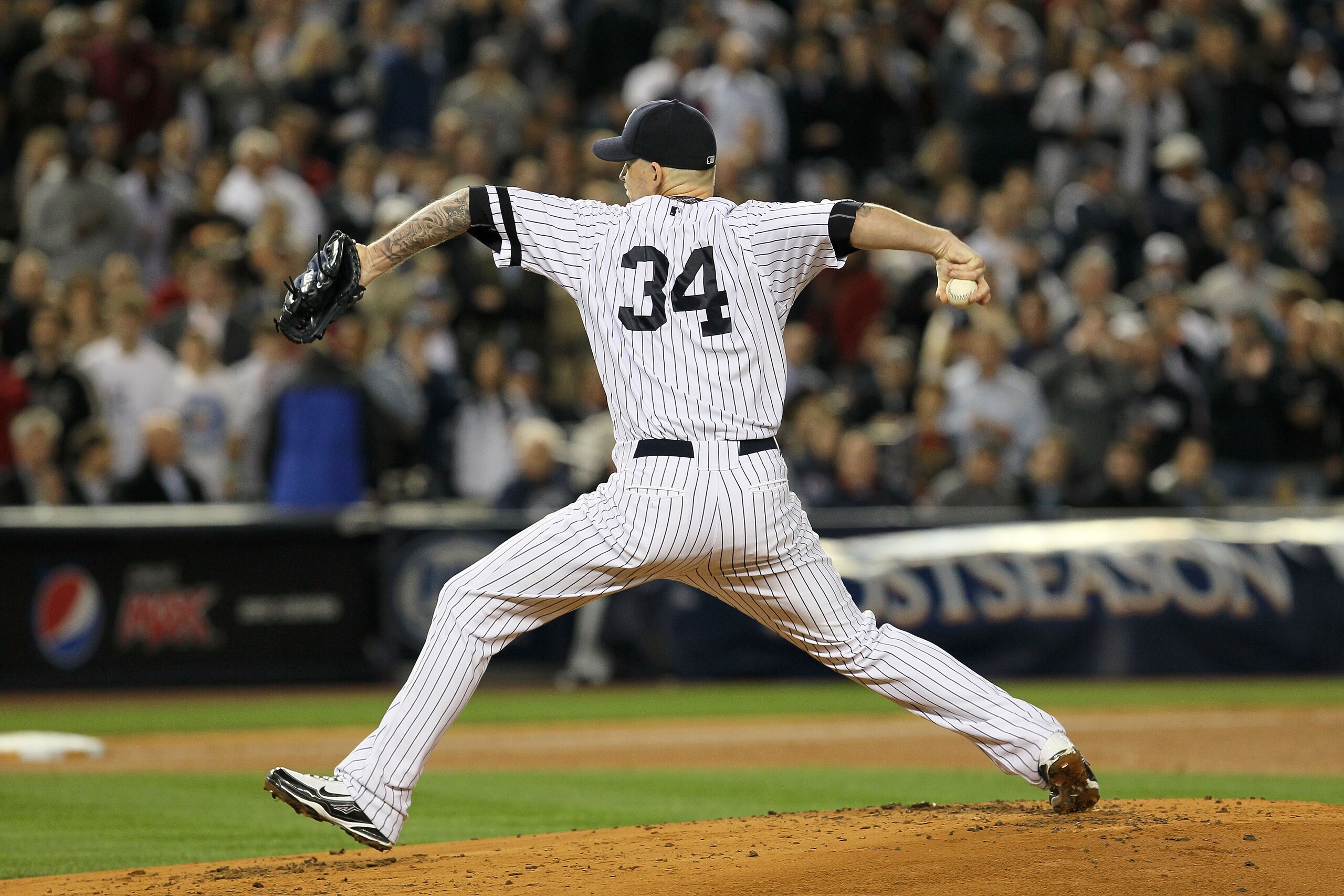 NEW YORK - OCTOBER 19:  A.J. Burnett #34 of the New York Yankees pitches against the Texas Rangers in Game Four of the ALCS during the 2010 MLB Playoffs at Yankee Stadium on October 19, 2010 in the Bronx borough of New York City. The Rangers won 10-3.  (P