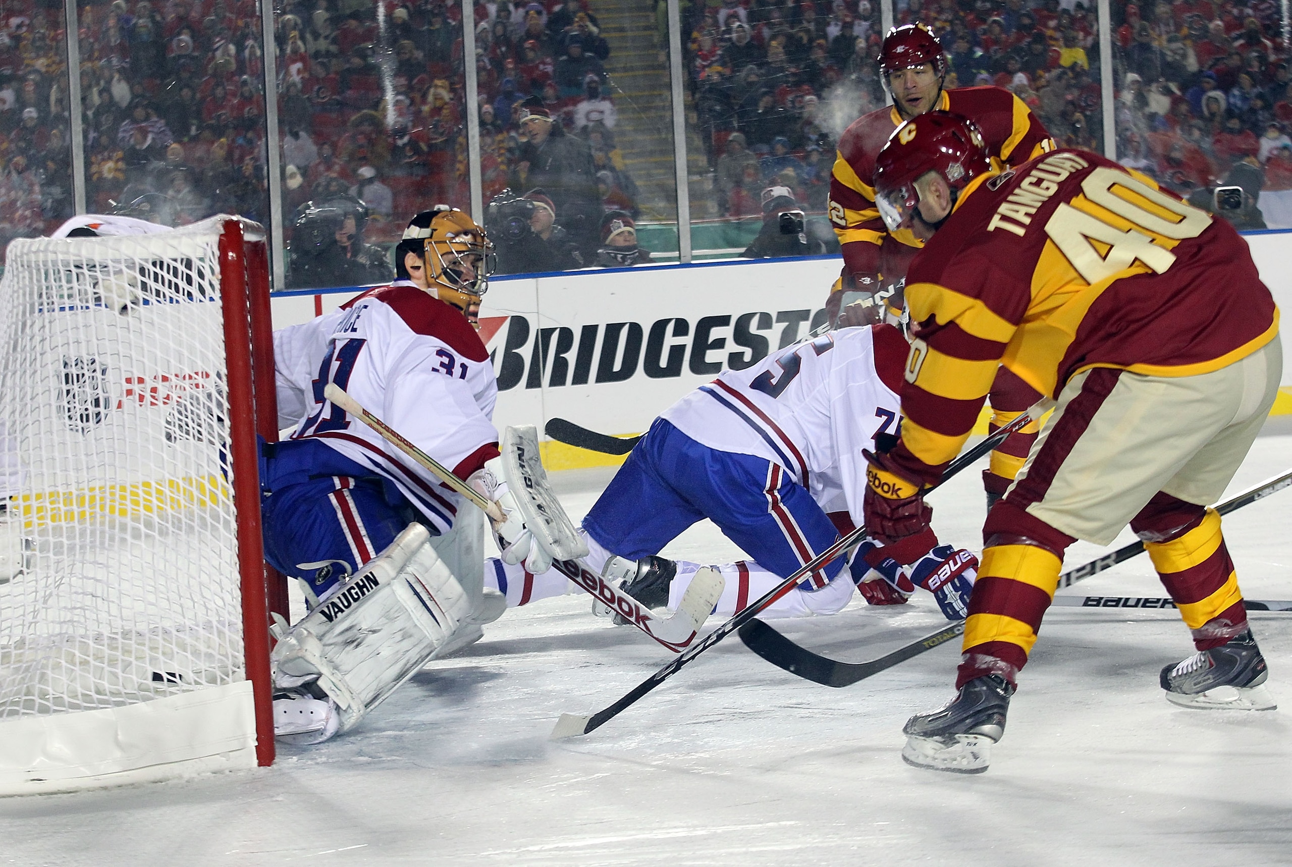 CALGARY, AB - FEBRUARY 20:  Alex Tanguay #40 of the Calgary Flames scores at 10:53 of the third period against Carey Price #31 of the Montreal Canadiens during the 2011 NHL Heritage Classic Game at McMahon Stadium on February 20, 2011 in Calgary, Alberta,