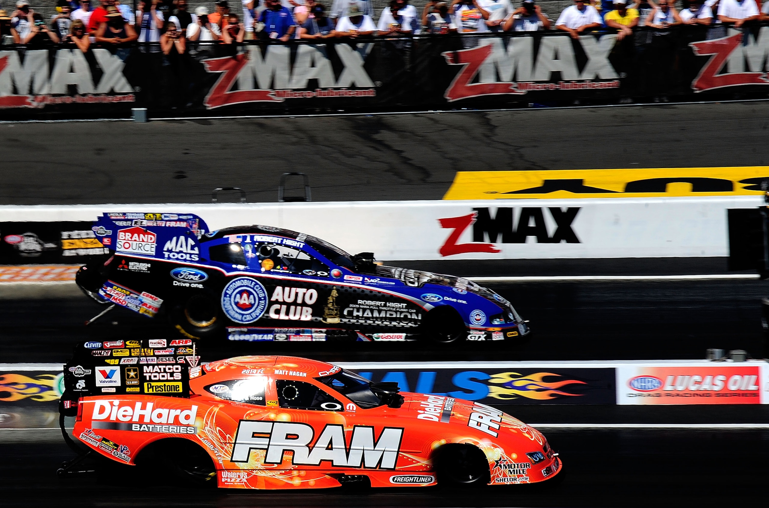 CONCORD, NC - SEPTEMBER 19:  Matt Hagan, drives the Fram Funny Car against Robert Hight, driver of the Auto Club Funny Car during the O'Reilly Auto Parts NHRA Nationals at zMax Dragway on September 19, 2010 in Concord, North Carolina.  (Photo by Rusty Jar