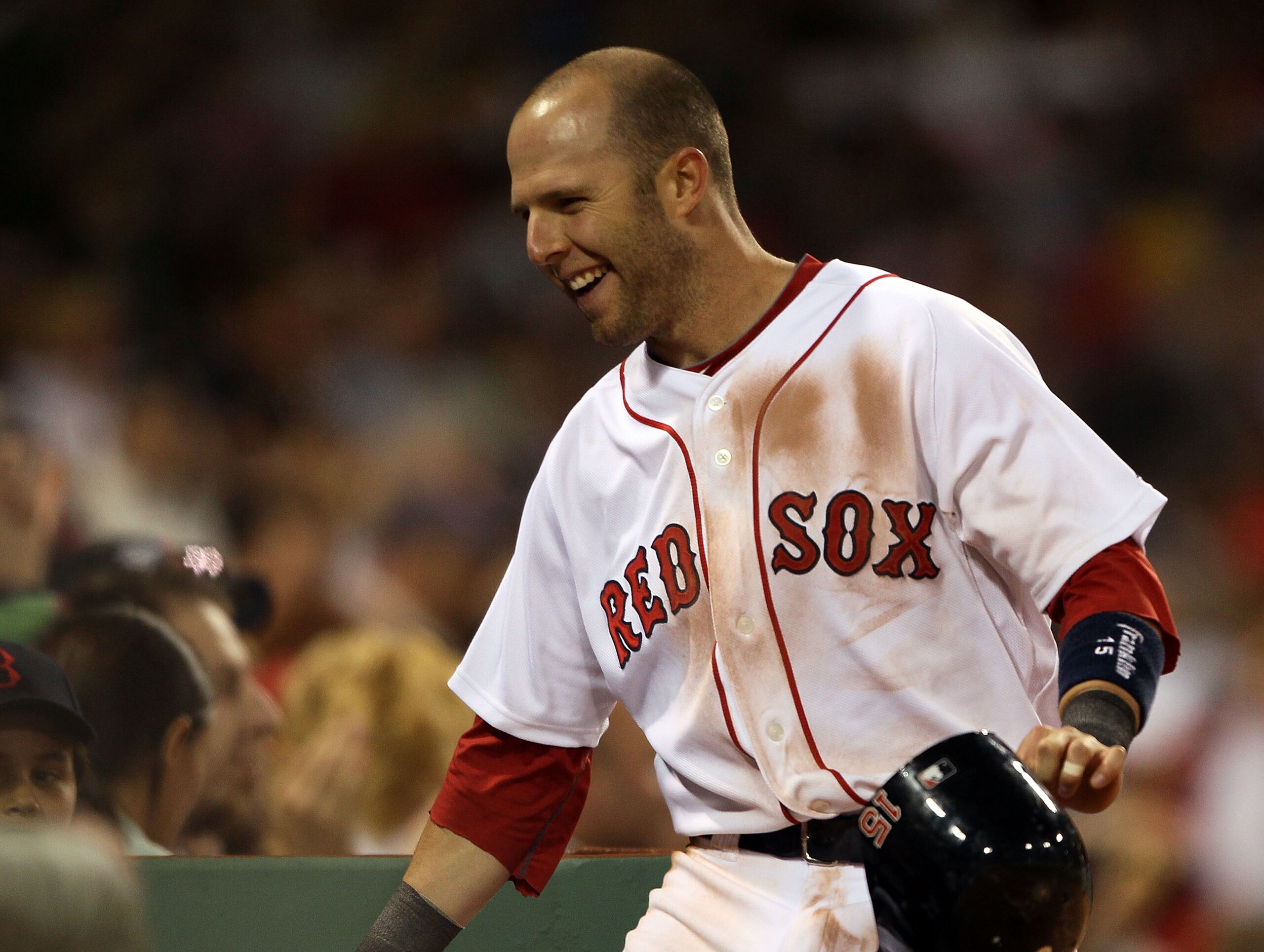 BOSTON - MAY 06:  Dustin Pedroia #15 of the Boston Red Sox celebrates with teammates in the dugout after he scored in the sixth inning against the Los Angeles Angels of Anaheim on May 6, 2010 at Fenway Park in Boston, Massachusetts.  (Photo by Elsa/Getty