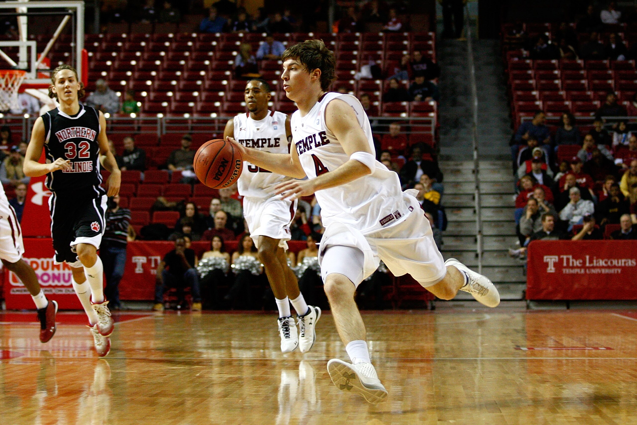 PHILADELPHIA, PA - DECEMBER 18:  Juan Fernandez #4 of the Temple Owls drives against the Northern Illinois Huskies at the Liacouras Center on December 18, 2010 in Philadelphia, Pennsylvania.  (Photo by Chris Chambers/Getty Images)