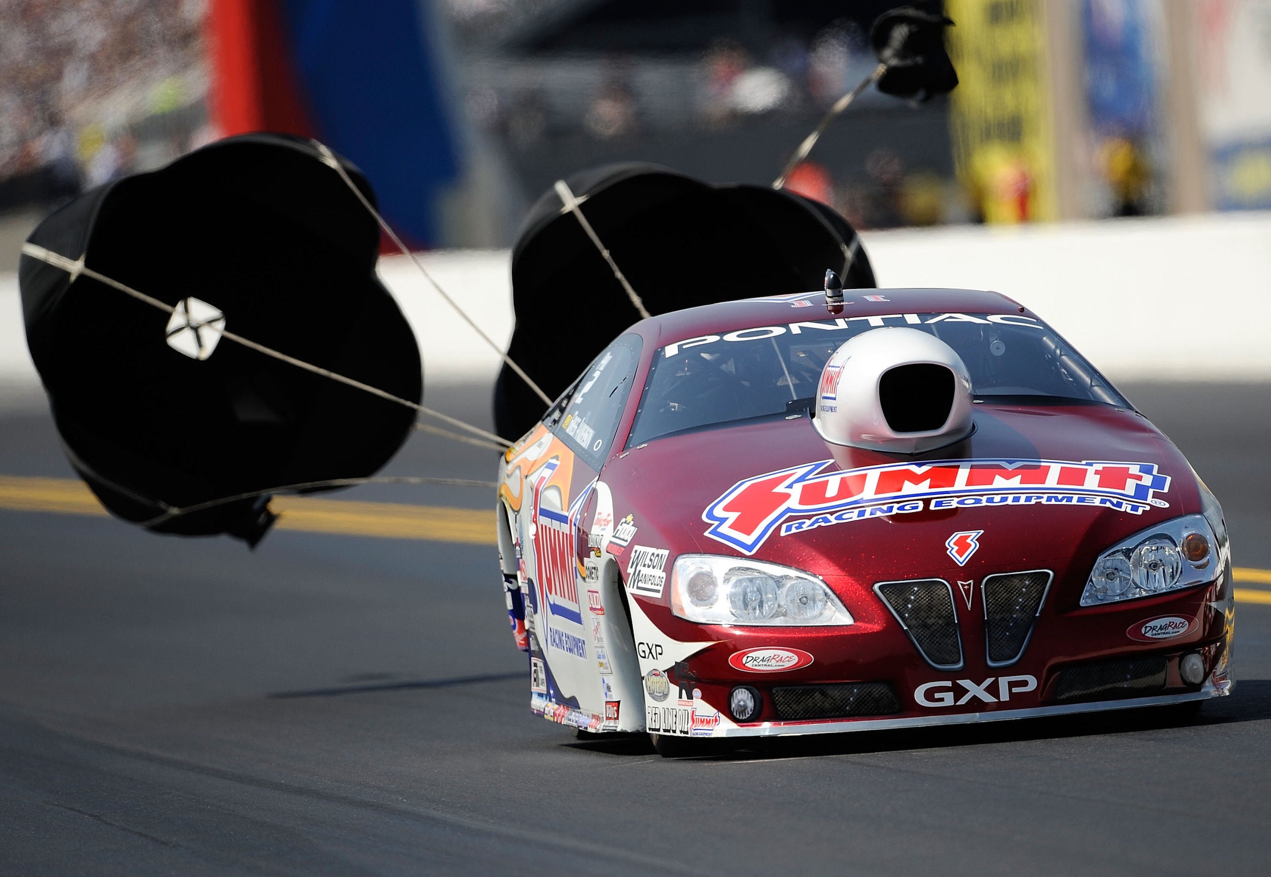CONCORD, NC - SEPTEMBER 18:   Greg Anderson drives The Summit Racing Equipment GXP  during qualifying for the 2010 O'Reilly Parts NHRA Nationals at zMax Dragway on September 18, 2010 in Concord, North Carolina.  (Photo by Rusty Jarrett/Getty Images)