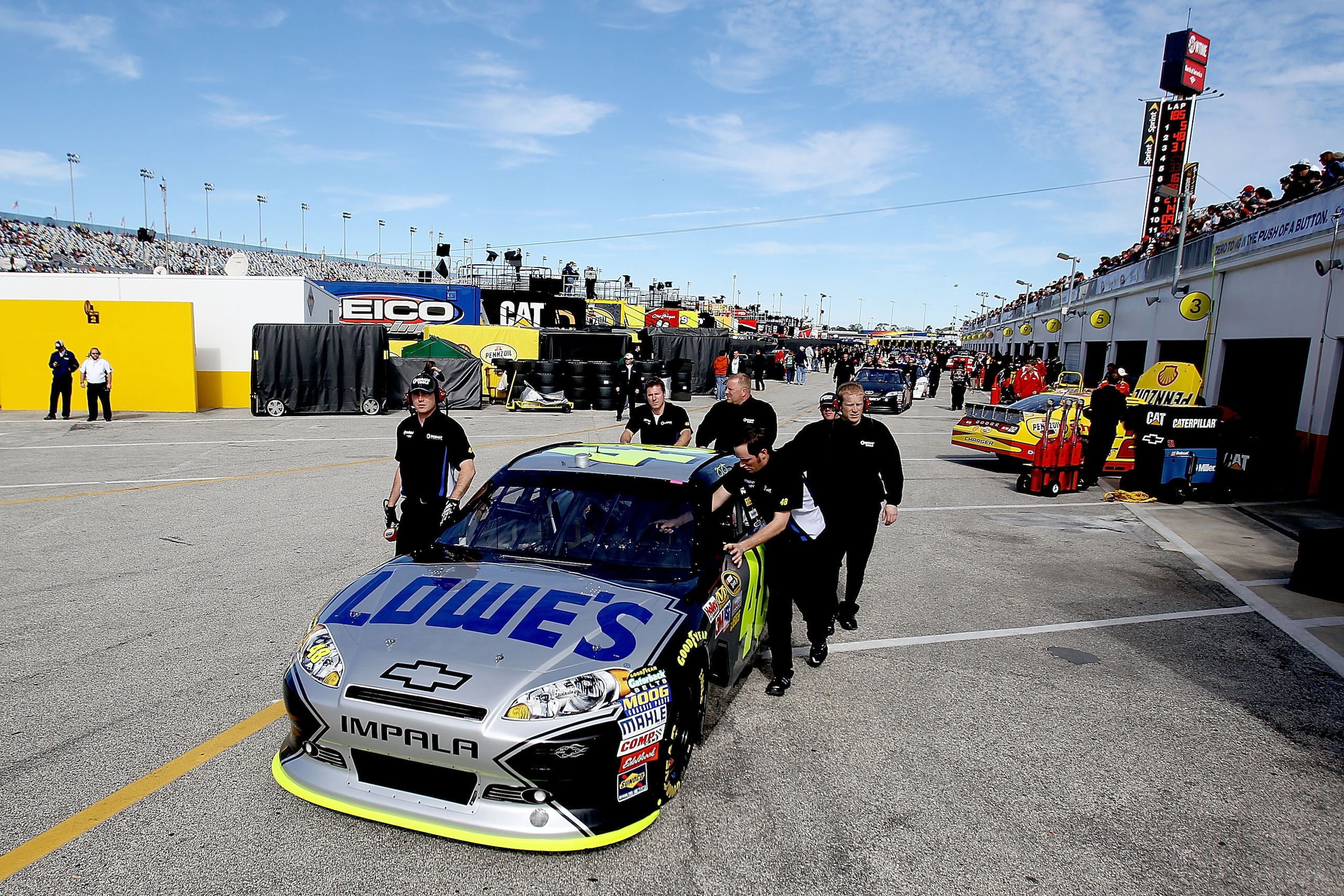 DAYTONA BEACH, FL - FEBRUARY 12: Crew members push the car of Jimmie Johnson, driver of the #48 Lowe's Chevrolet, through the garage area during practice for the NASCAR Sprint Cup Series Daytona 500 at Daytona International Speedway on February 12, 2011 DAYTONA BEACH, FL - FEBRUARY 12: Crew members push the car of Jimmie Johnson, driver of the #48 Lowe's Chevrolet, through the garage area during practice for the NASCAR Sprint Cup Series Daytona 500 at Daytona International Speedway on February 12, 2011