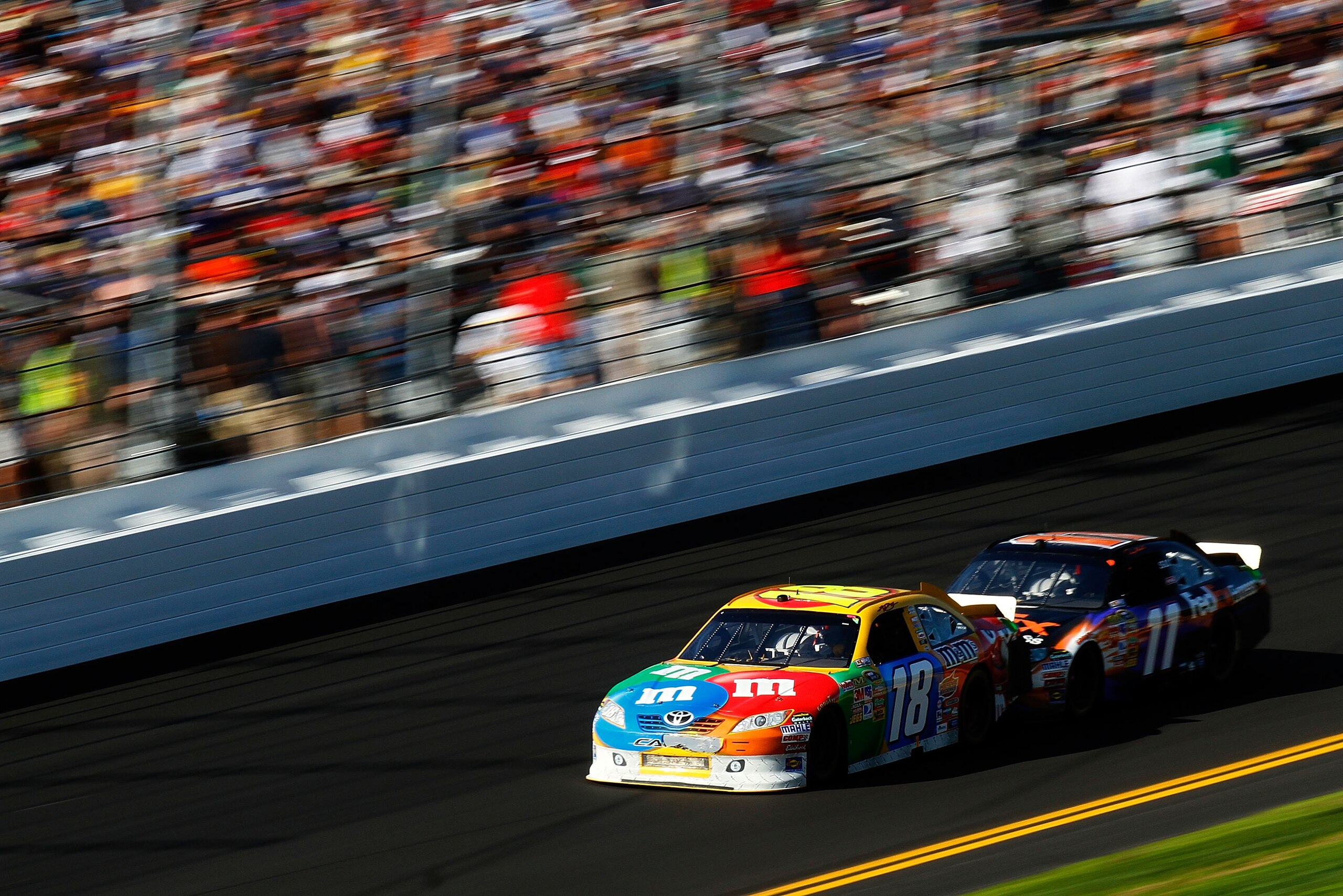 DAYTONA BEACH, FL - FEBRUARY 20: Kyle Busch, driver of the #18 M&M's Toyota, and Denny Hamlin, driver of the #11 FedEx Toyota, race during the NASCAR Sprint Cup Series Daytona 500 at Daytona International Speedway on February 20, 2011 in Daytona Beach, F DAYTONA BEACH, FL - FEBRUARY 20: Kyle Busch, driver of the #18 M&M's Toyota, and Denny Hamlin, driver of the #11 FedEx Toyota, race during the NASCAR Sprint Cup Series Daytona 500 at Daytona International Speedway on February 20, 2011 in Daytona Beach, F