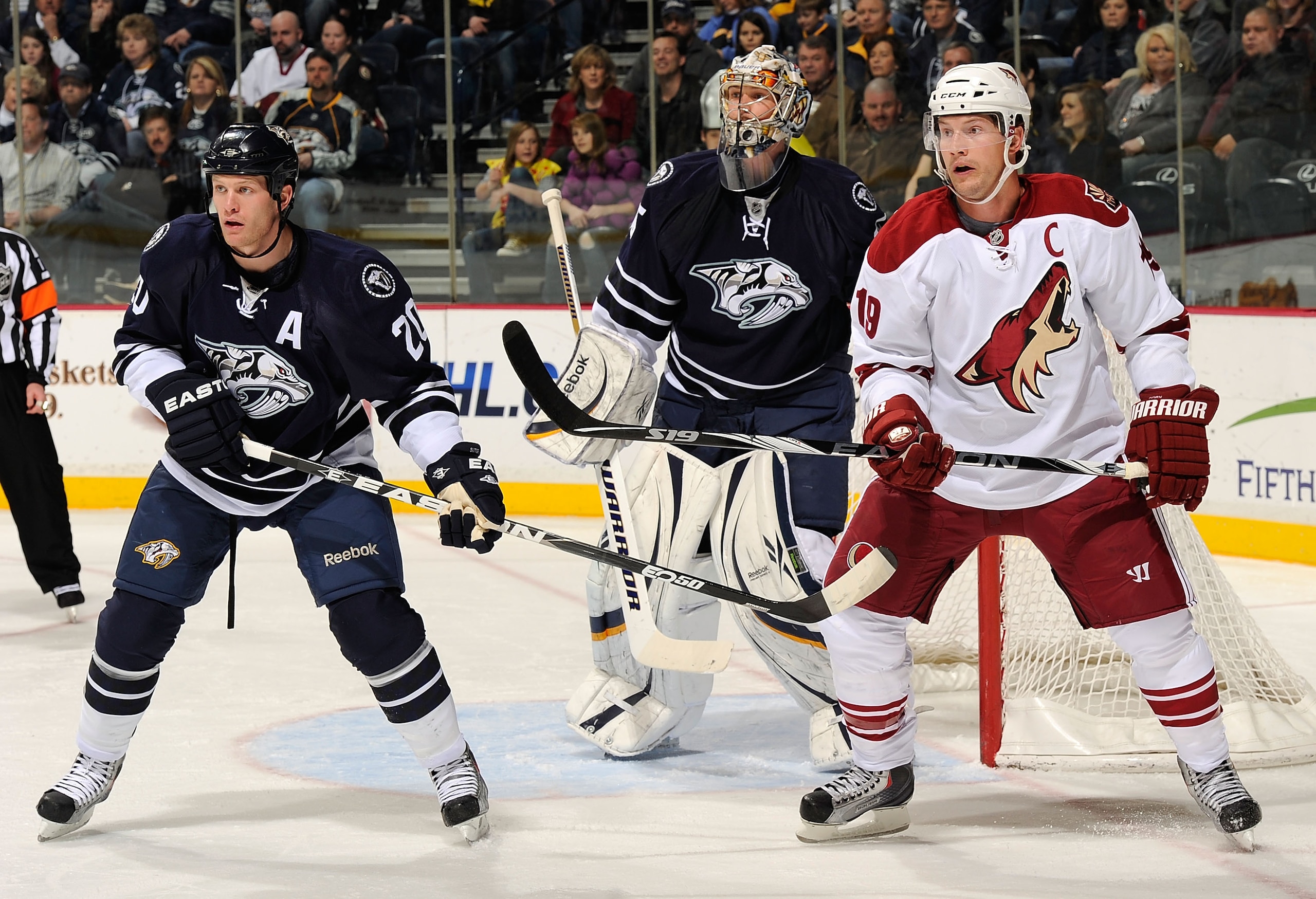 NASHVILLE, TN - FEBRUARY 19:  Shane Doan #19 of the Phoenix Coyotes skates against Ryan Suter #20 and Pekka Rinne #35 of the Nashville Predators on February 19, 2011 at the Bridgestone Arena in Nashville, Tennessee.  (Photo by Frederick Breedon/Getty Imag