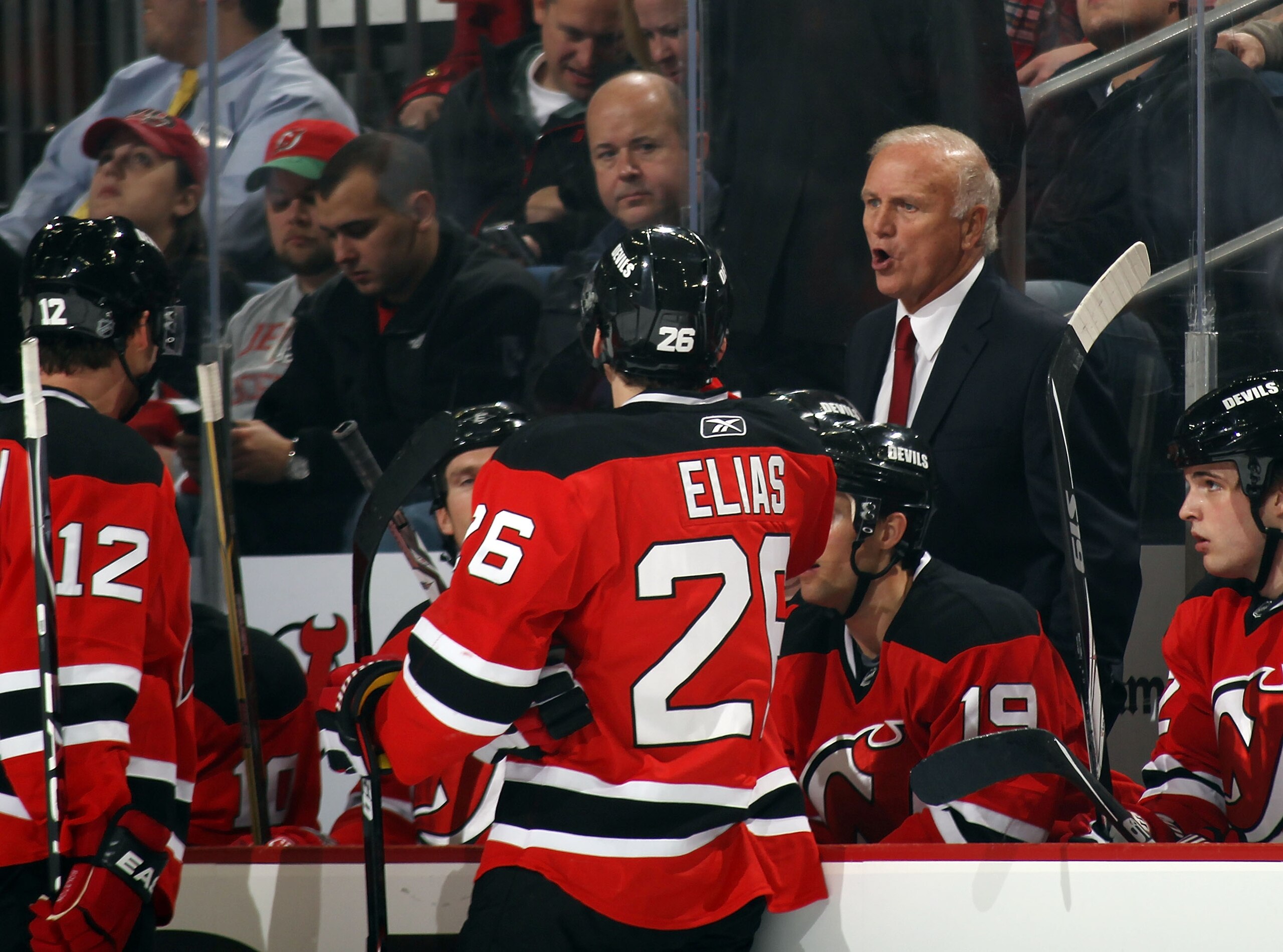 NEWARK, NJ - JANUARY 06:  Head coach Jacques Lemaire of the New Jersey Devils instructs his players during the game against the Philadelphia Flyers at the Prudential Center on January 6, 2011 in Newark, New Jersey. The Flyers defeated the Devils 4-2.  (Ph