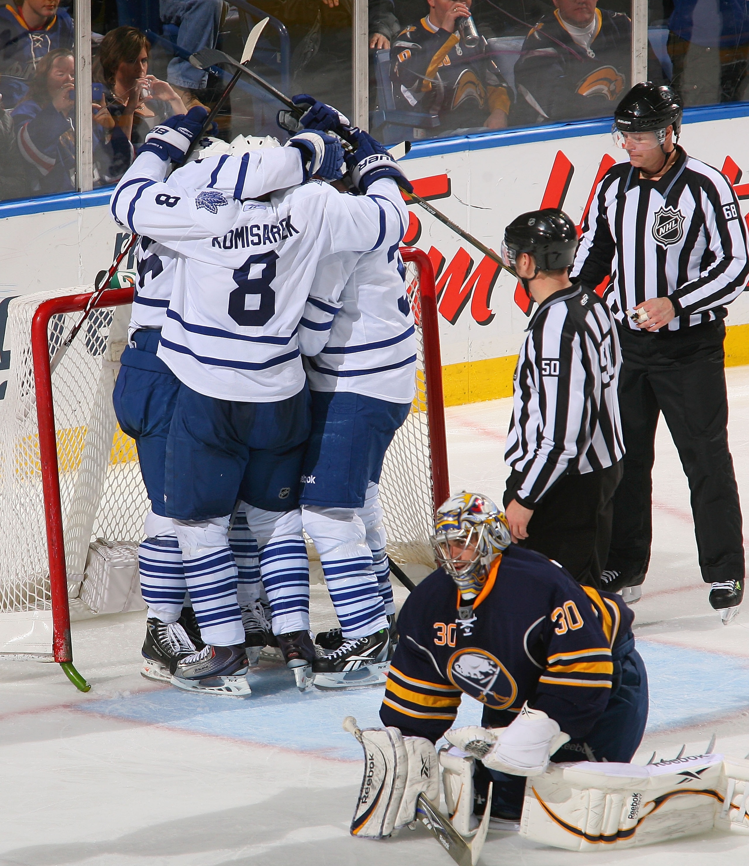 BUFFALO, NY - FEBRUARY 16: Mike Komisarek #8, Dion Phaneuf #3, Tim Brent #37 and Joey Crabb #46 celebrate Crabb's game winning goal behind Ryan Miller #30  of the Buffalo Sabres the Toronto Maple Leafs at HSBC Arena on February 16, 2011 in Buffalo, New Yo
