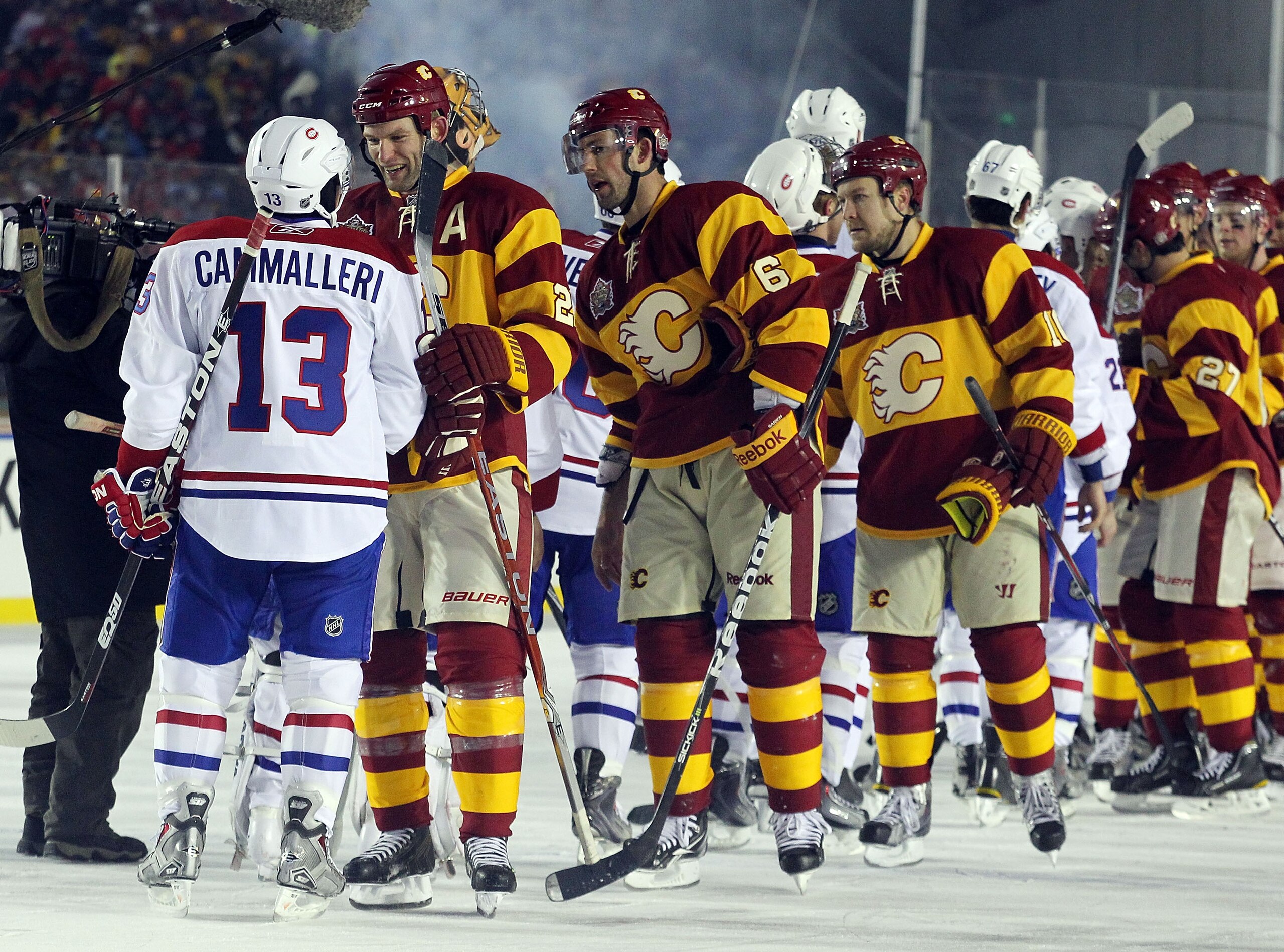 CALGARY, AB - FEBRUARY 20: Mike Cammalleri #13 of the Montreal Canadiens and Robyn Regehr #28 of the Calgary Flames shake hands following the Flames 4-0 victory over the Canadiens in the 2011 NHL Heritage Classic Game at McMahon Stadium on February 20, 20