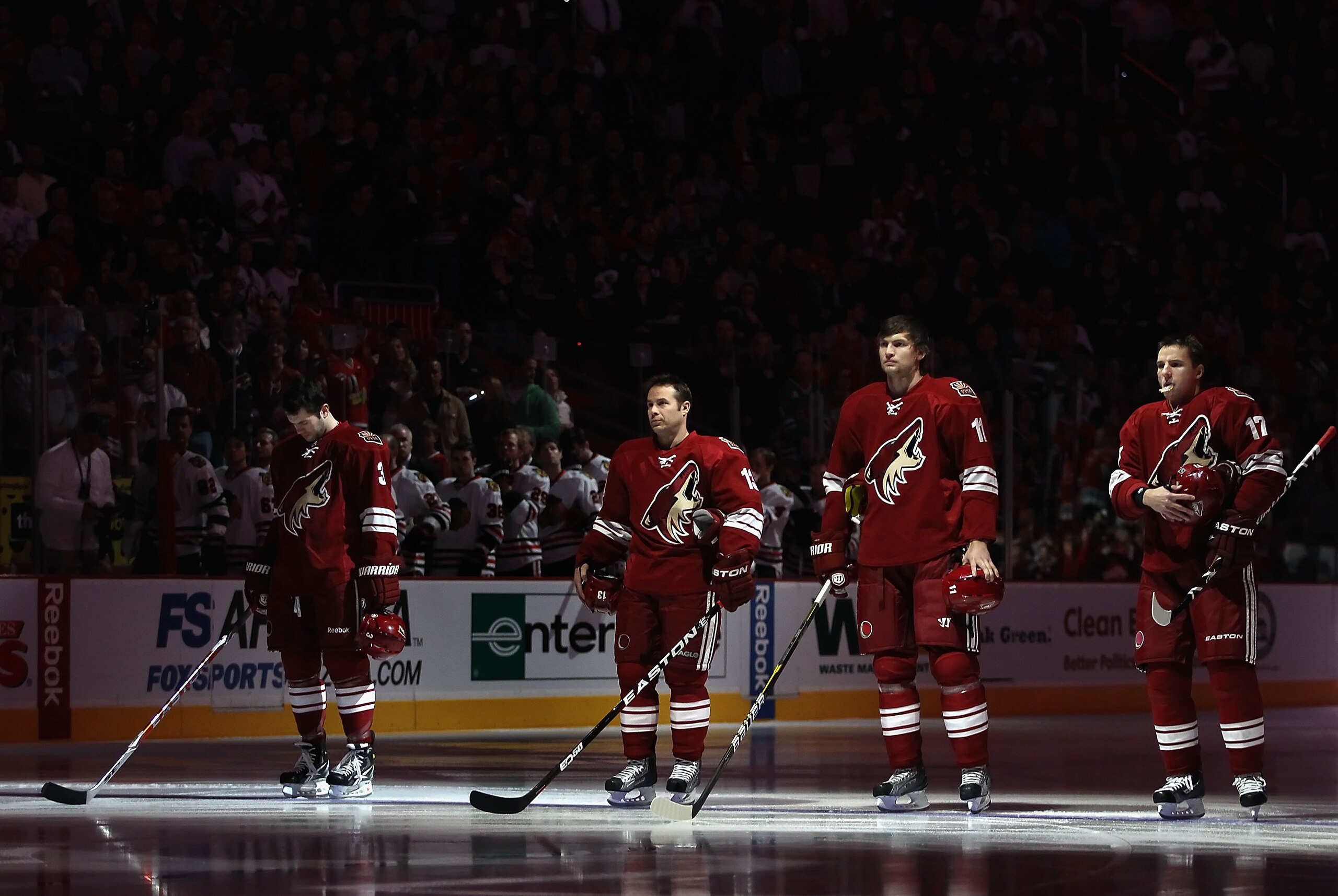 GLENDALE, AZ - FEBRUARY 12:  (L-R) Keith Yandle #3, Ray Whitney #13, Martin Hanzal #11 and Radim Vrbata #17 of the Phoenix Coyotes stand attended for the National Anthem before the NHL game against the Chicago Blackhawks at Jobing.com Arena on February 12