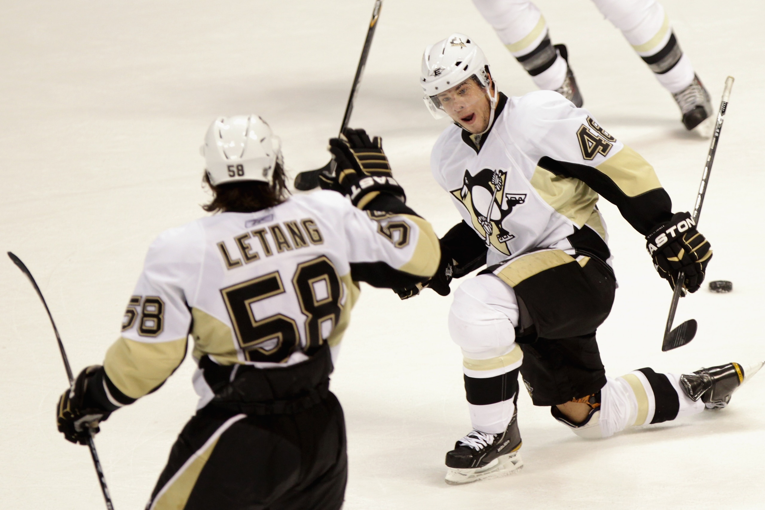 DENVER, CO - FEBRUARY 16:  Tyler Kennedy #48 of the Pittsburgh Penguins celebrates his game winning goal in overtime with Kris Letang #58 against the Colorado Avalanche at the Pepsi Center on February 16, 2011 in Denver, Colorado. The Penguins defeated th