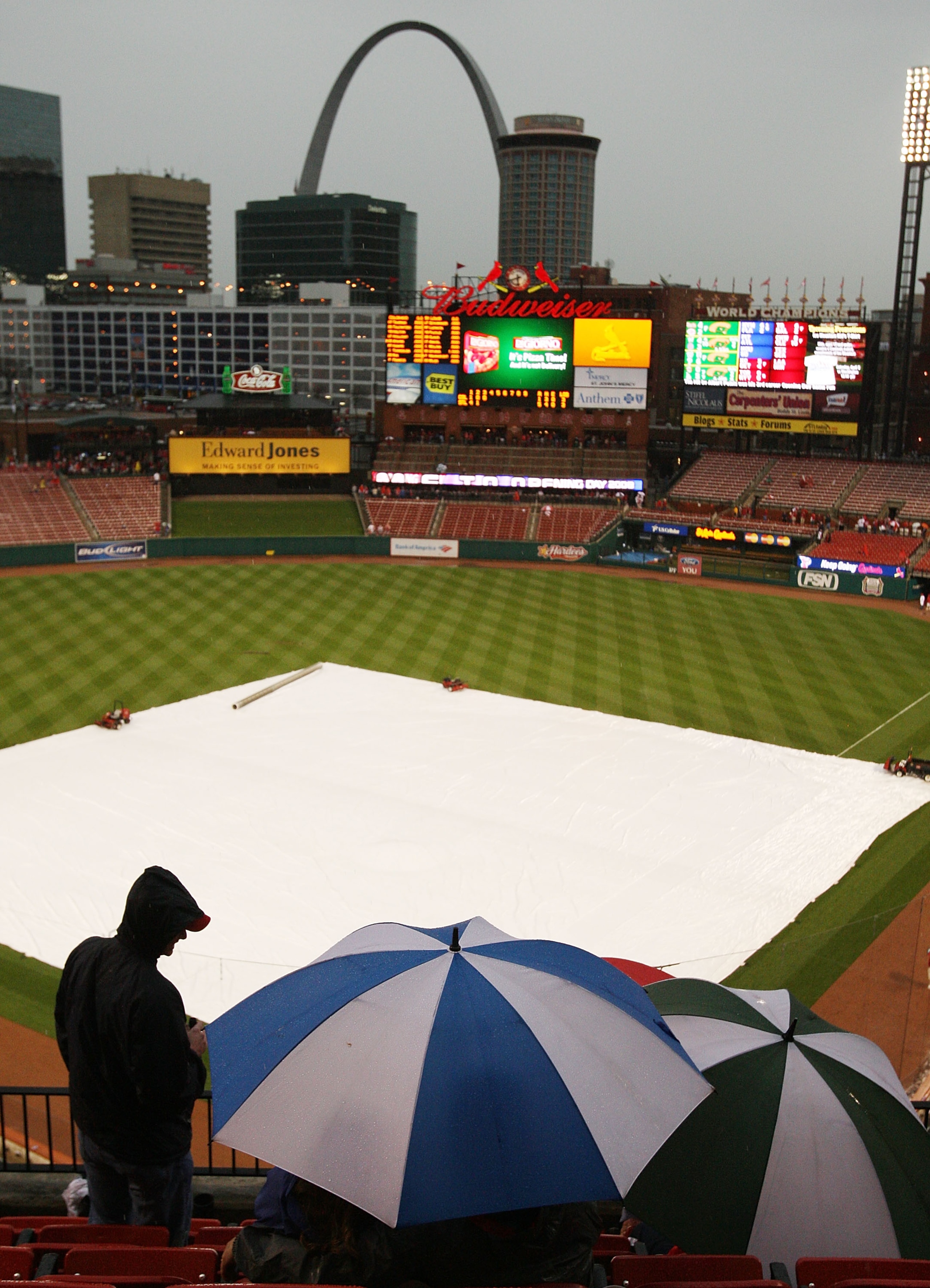 ST. LOUIS - MARCH 31:  Fans wait to see whether the St. Louis Cardinals home opener will continue after rain halted play in the third inning against the Colorado Rockies March 31,2008 at Busch Stadium in St. Louis, Missouri.  (Photo by Elsa/Getty Images)