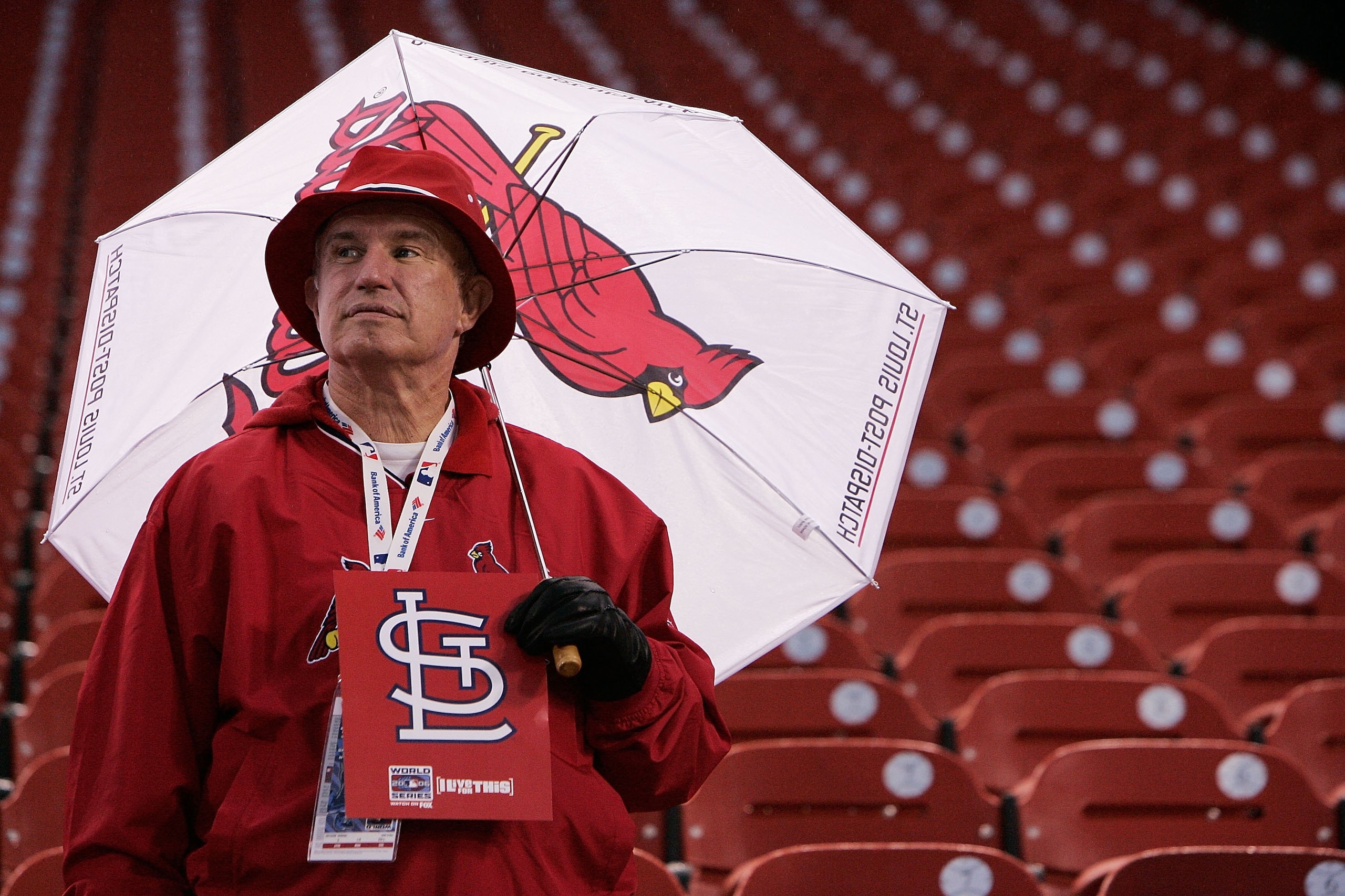 ST LOUIS - OCTOBER 25:  A Cardinals fan attempts to stay dry under an umbrella before the start of Game Four of the 2006 World Series between the Detroit Tigers and the St. Louis Cardinals on October 25, 2006 at Busch Stadium in St. Louis, Missouri.  (Pho