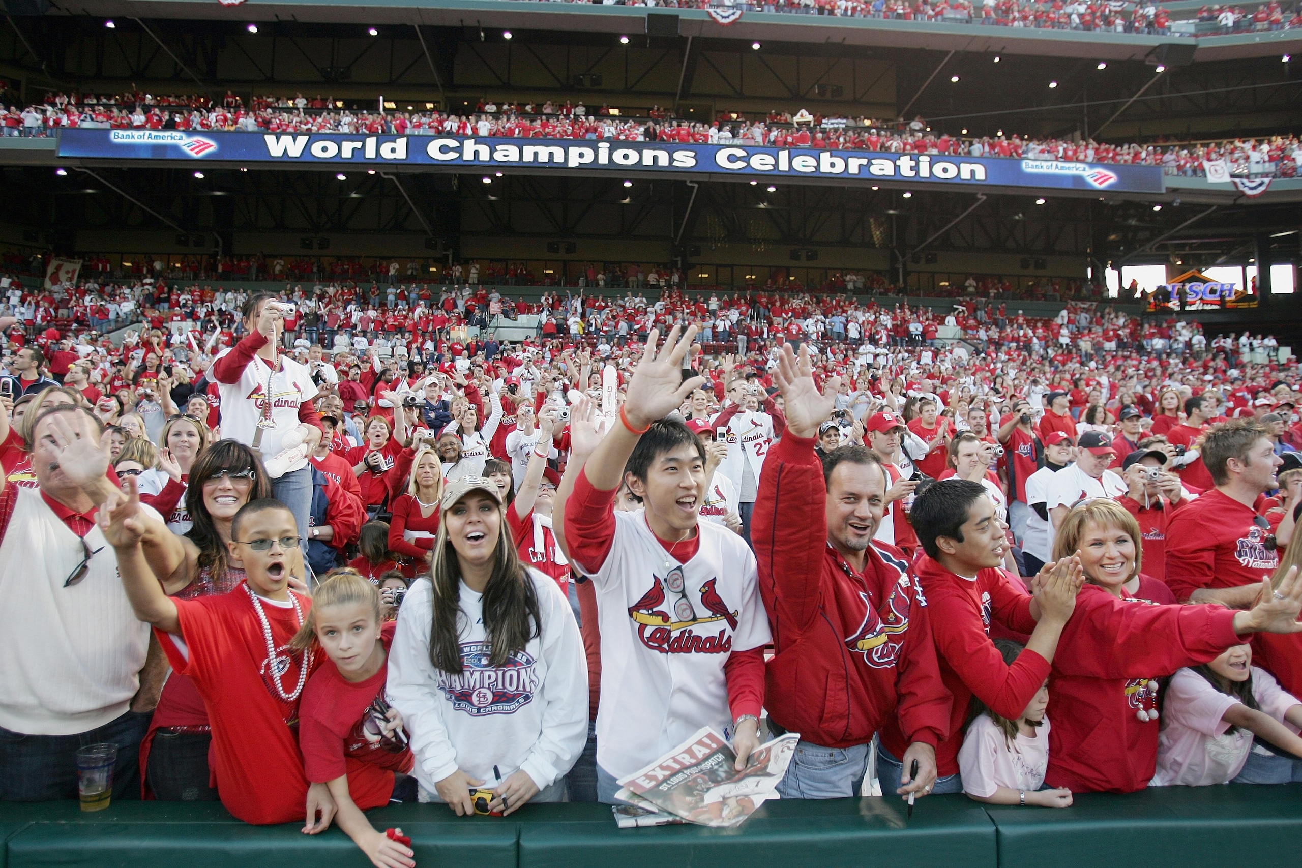 ST. LOUIS - OCTOBER 29:  Fans of the St. Louis Cardinals cheer as the players take the field  during the World Series Victory Parade and Rally on October 29, 2006 at Busch Stadium in St. Louis, Missouri.  (Photo by Elsa/Getty Images)