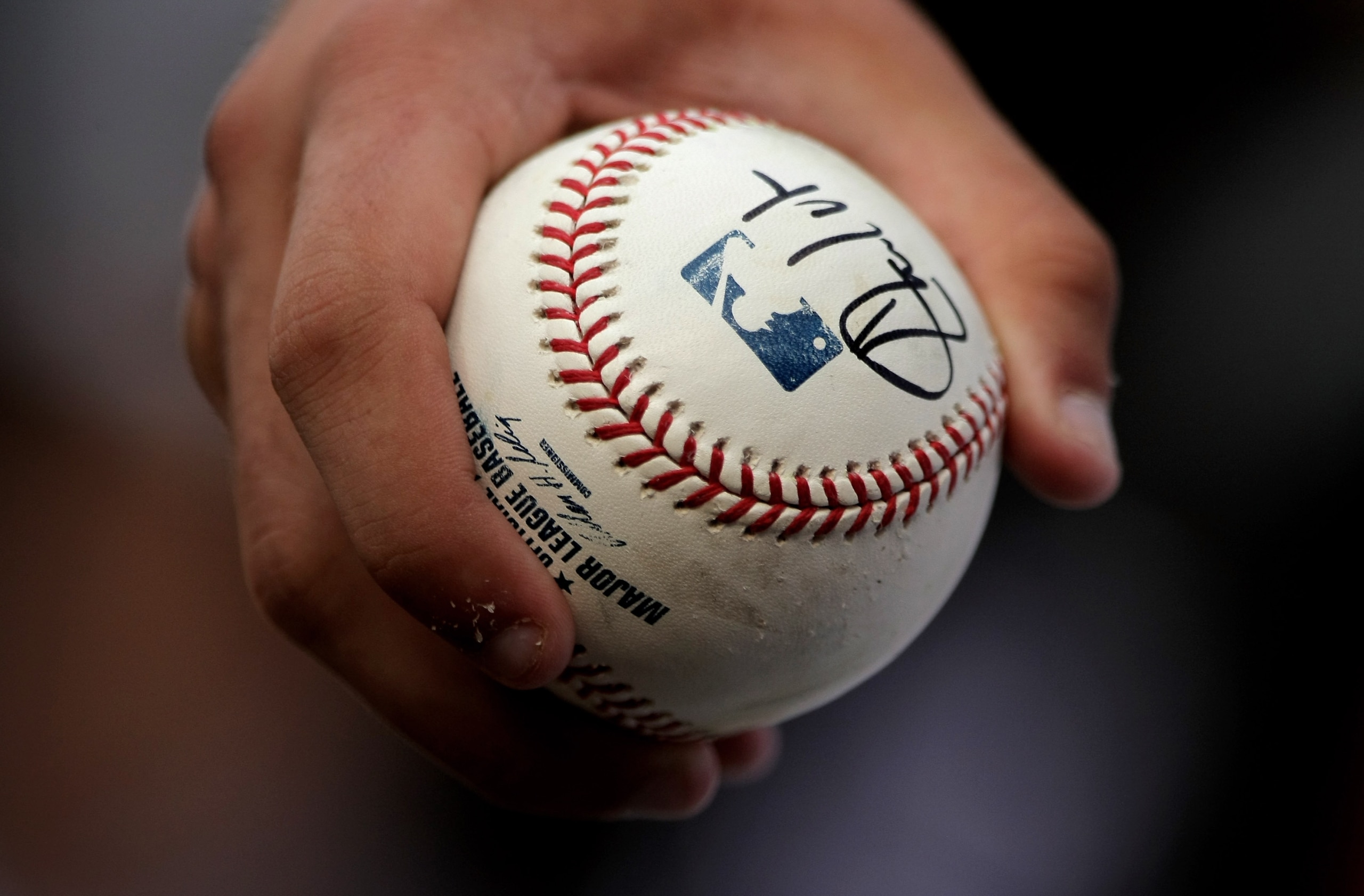 DENVER - MAY 06:  A fan holds a baseball the he got autgraphed at the game between the St. Louis Cardinals and the Colorado Rockies at Coors Field on May 6, 2008 in Denver, Colorado.  (Photo by Doug Pensinger/Getty Images)