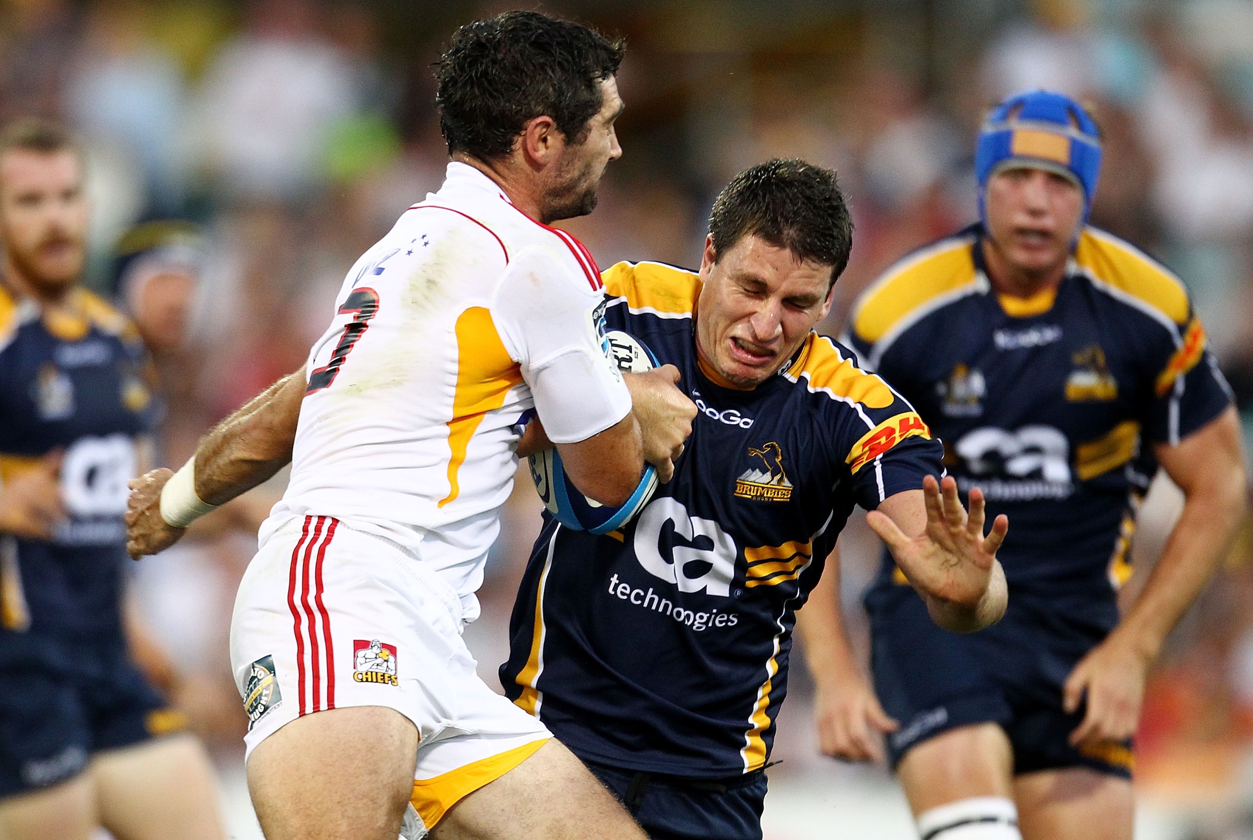 CANBERRA, AUSTRALIA - FEBRUARY 19:  Mitchell Chapman of the Brumbies is tackled during the round one Super Rugby match between the Brumbies and the Chiefs at Canberra Stadium on February 19, 2011 in Canberra, Australia.  (Photo by Mark Nolan/Getty Images)